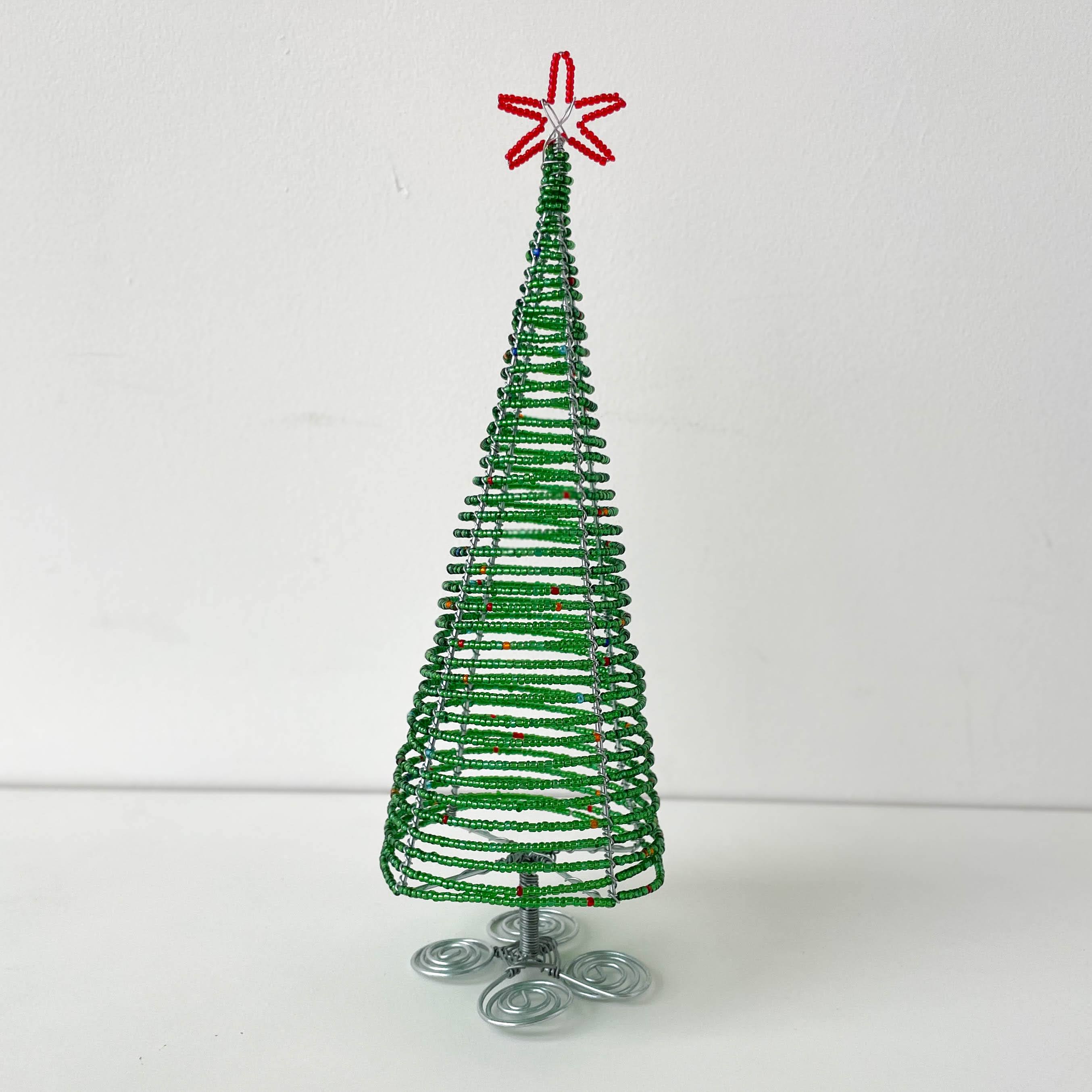 Green beaded Christmas tree with a red star on a white background