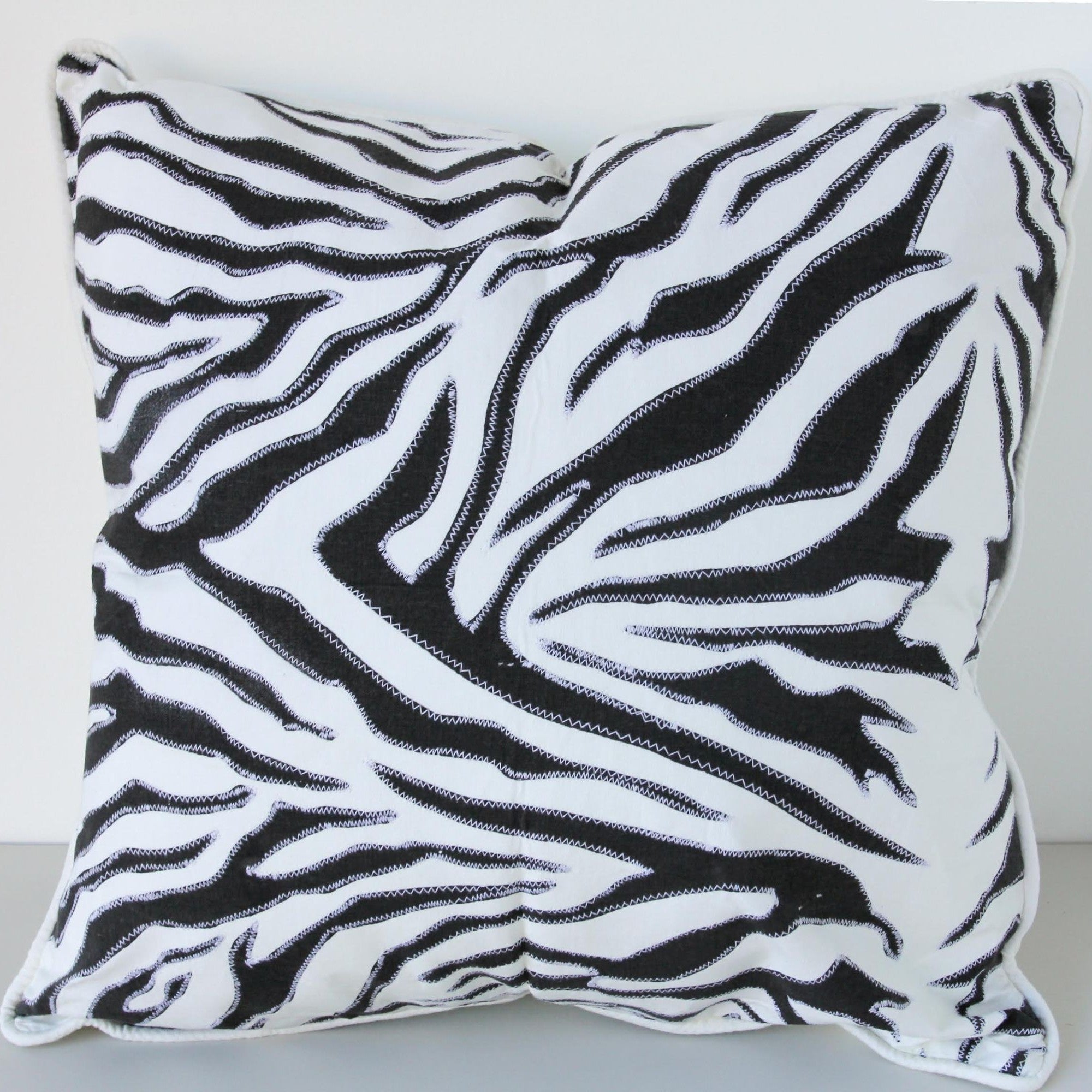 Zebra print pillow on a white background