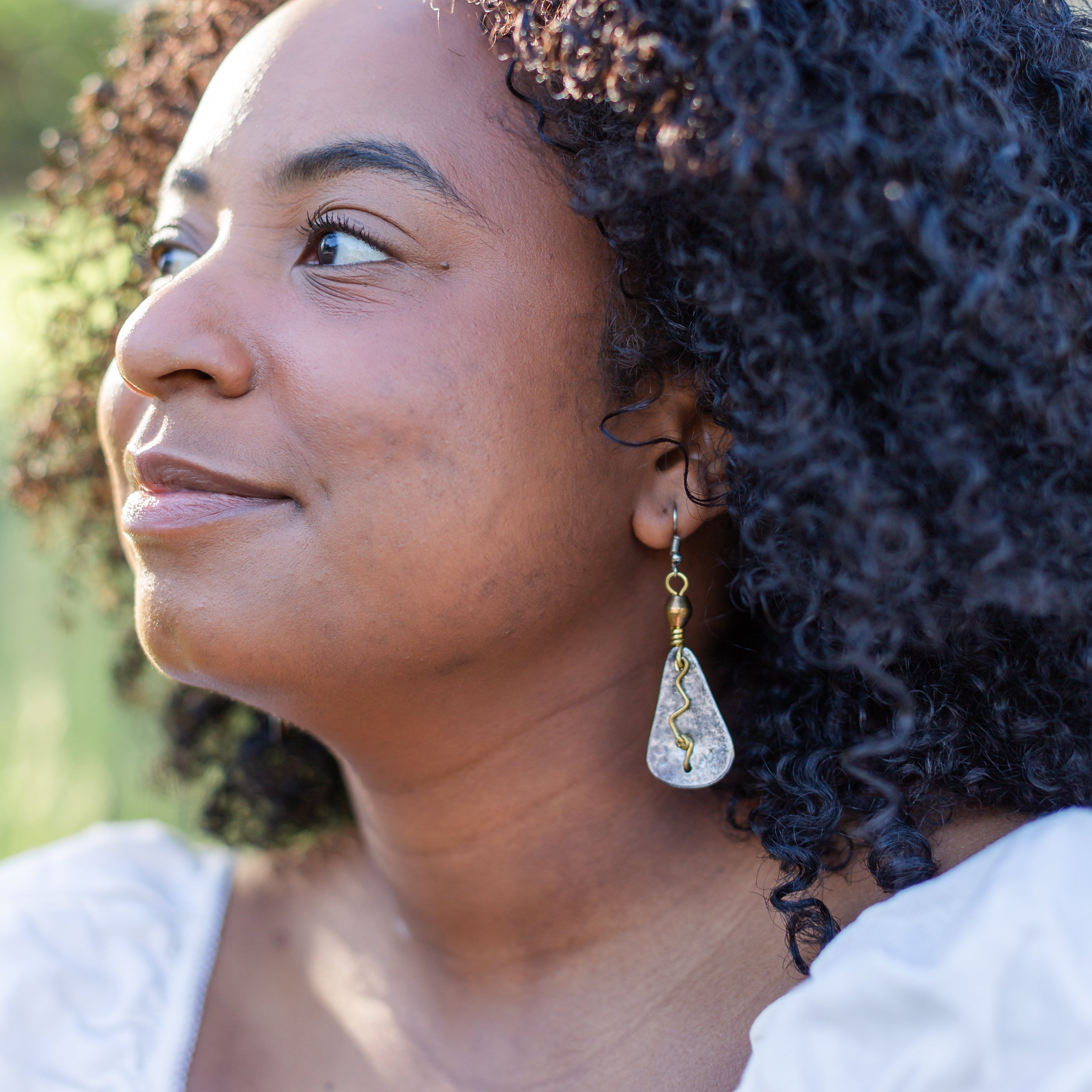 model gazing to the left displaying earrings