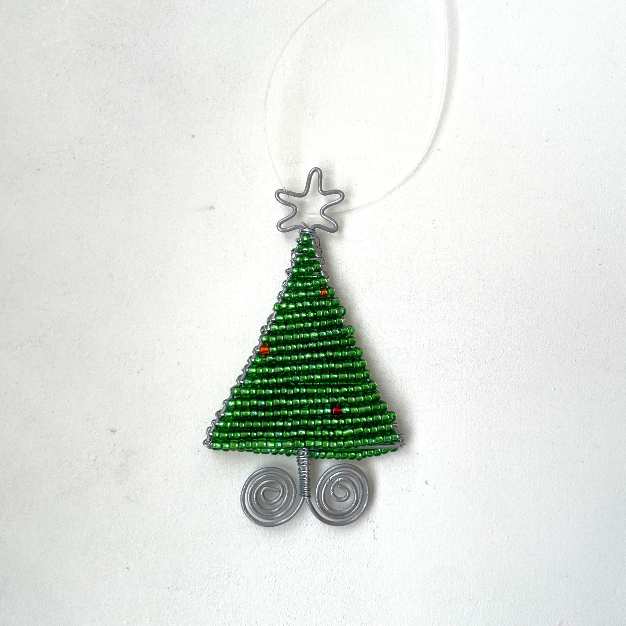 Beaded Christmas tree ornament on a white background