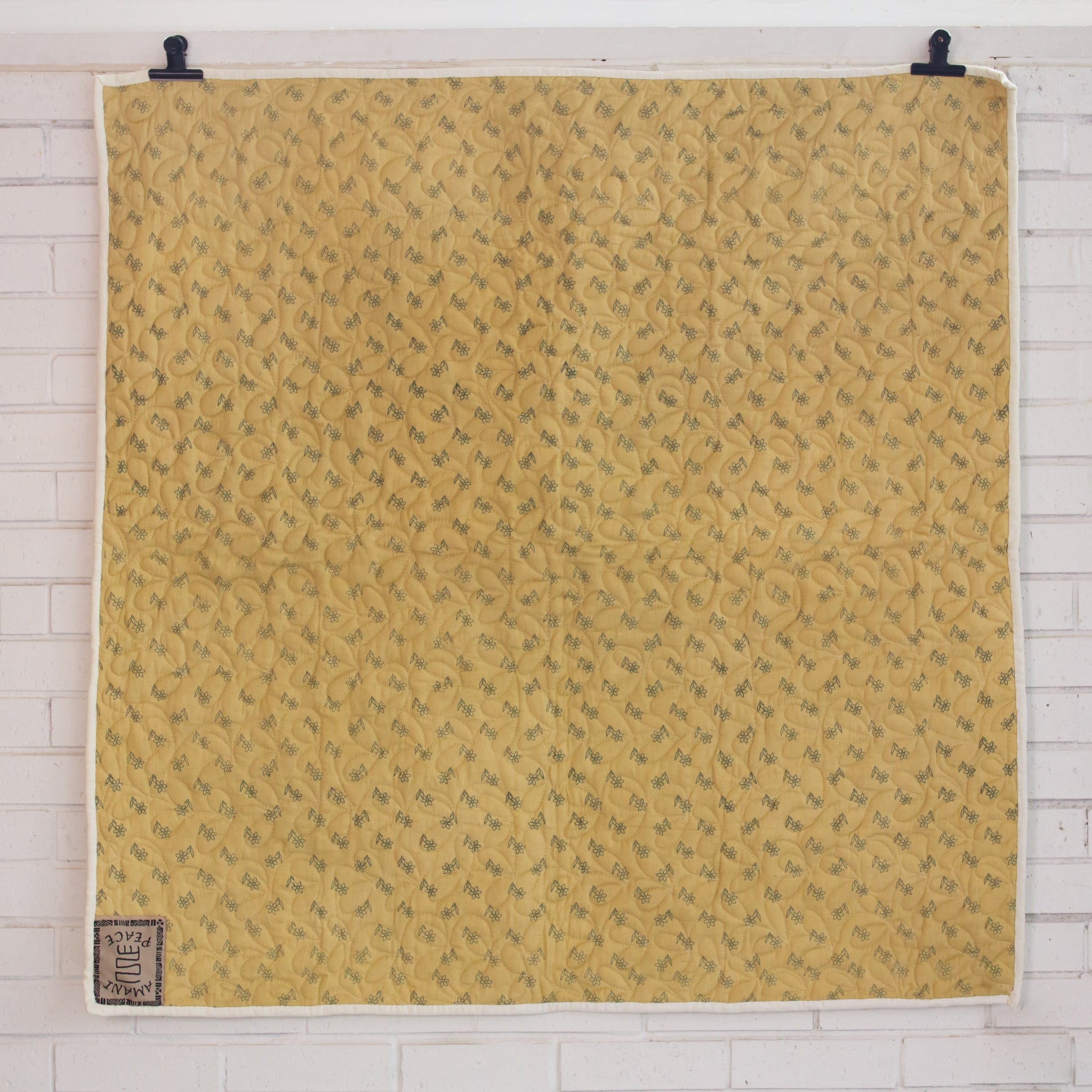 Hand stitched, hand dyed fabrics pieced together for an Amani ya Juu baby quilt