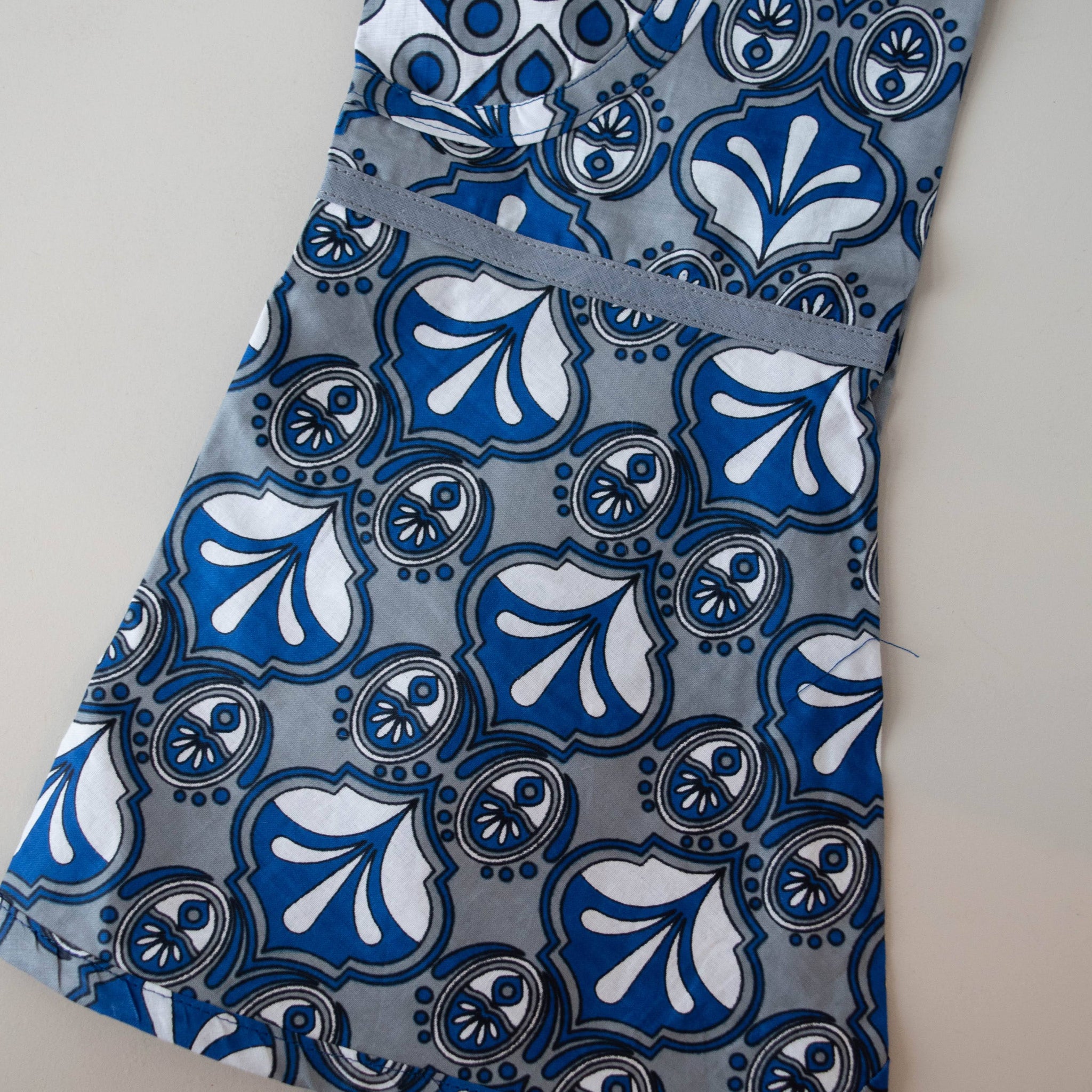 Kanga apron handmade by the women of Amani ya Juu in Kenya for a fair trade social enterprise