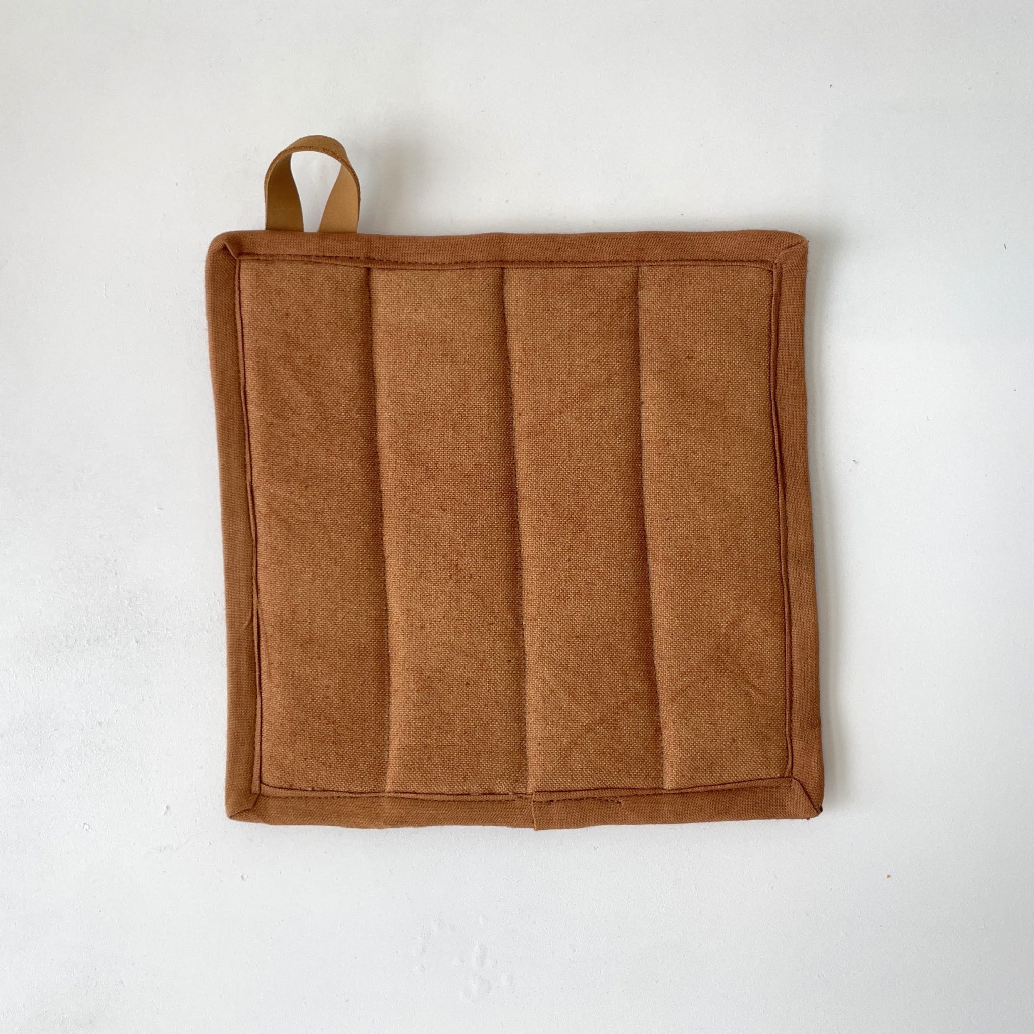 Brown pot holder with a handle on a white background