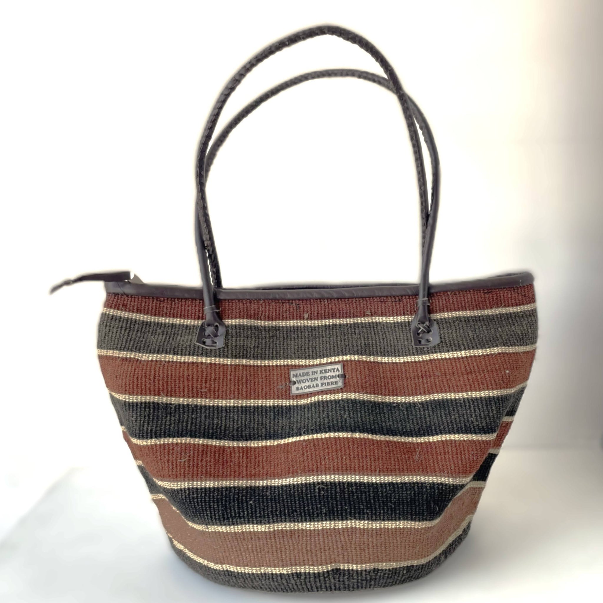 Striped handbag with brown, black, and beige pattern on a white background