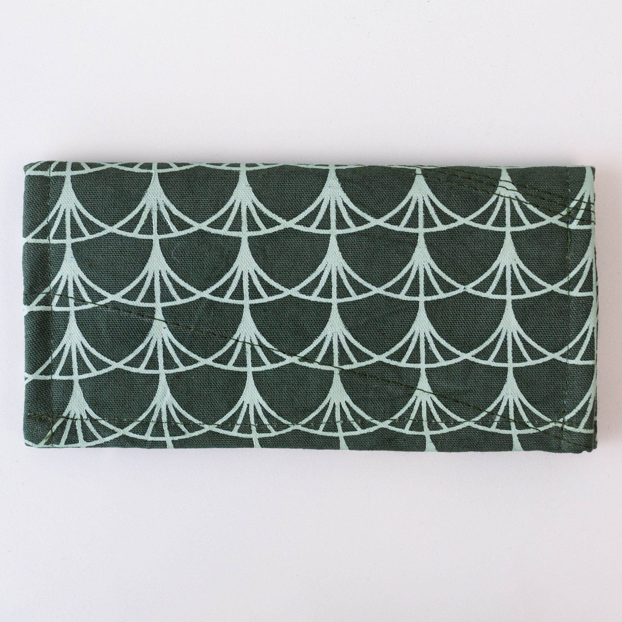 Folded fabric wallet with geometric pattern on a white background