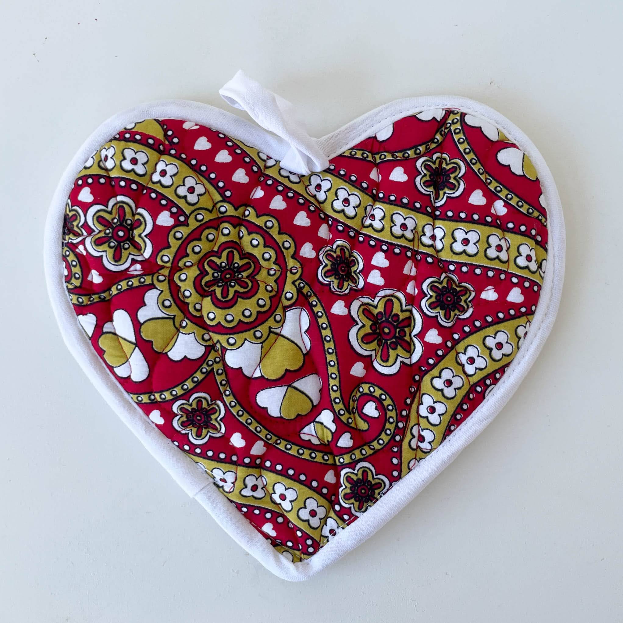 Heart-shaped pot holder with colorful paisley design on a white background