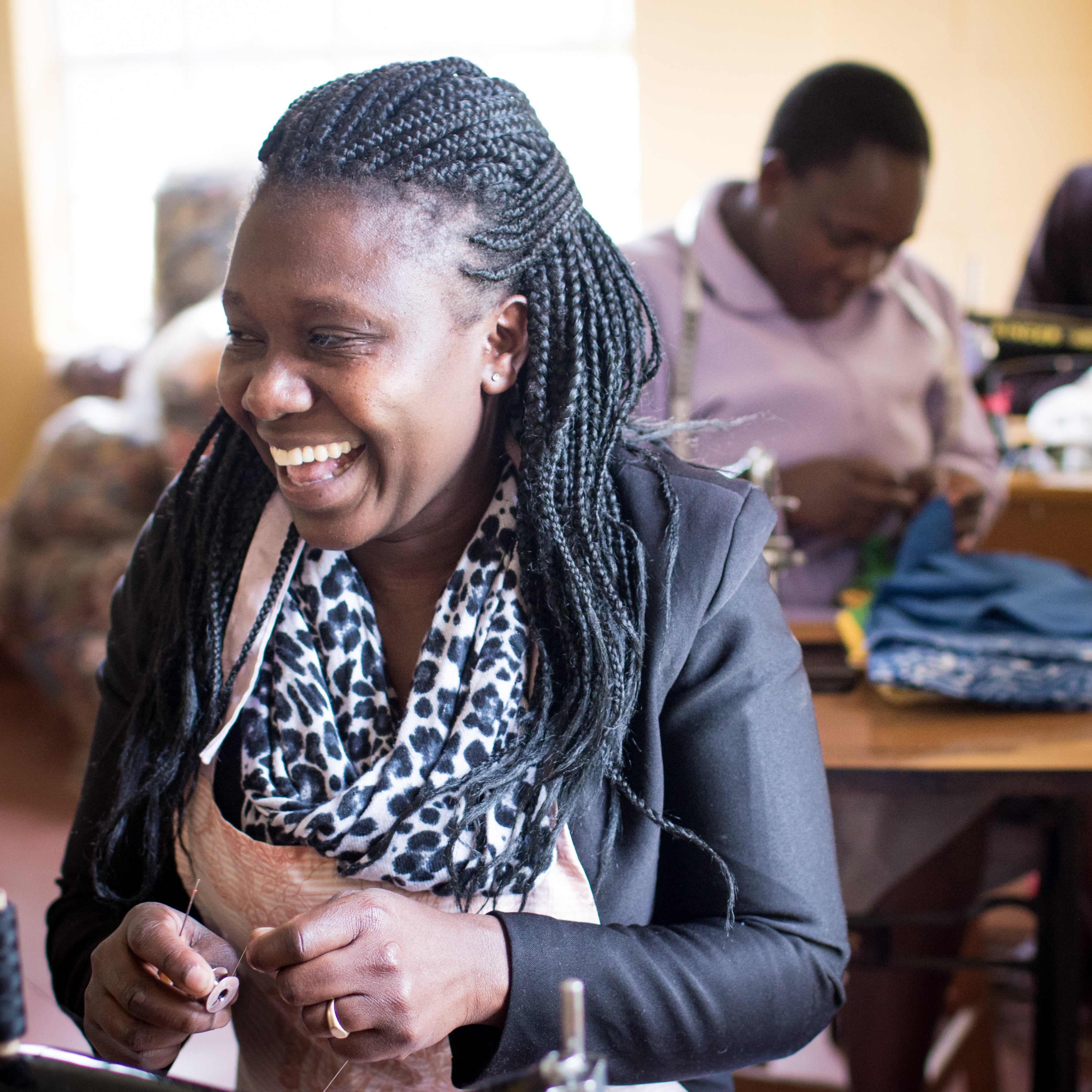 Woman working at a sewing machine in a workshop setting