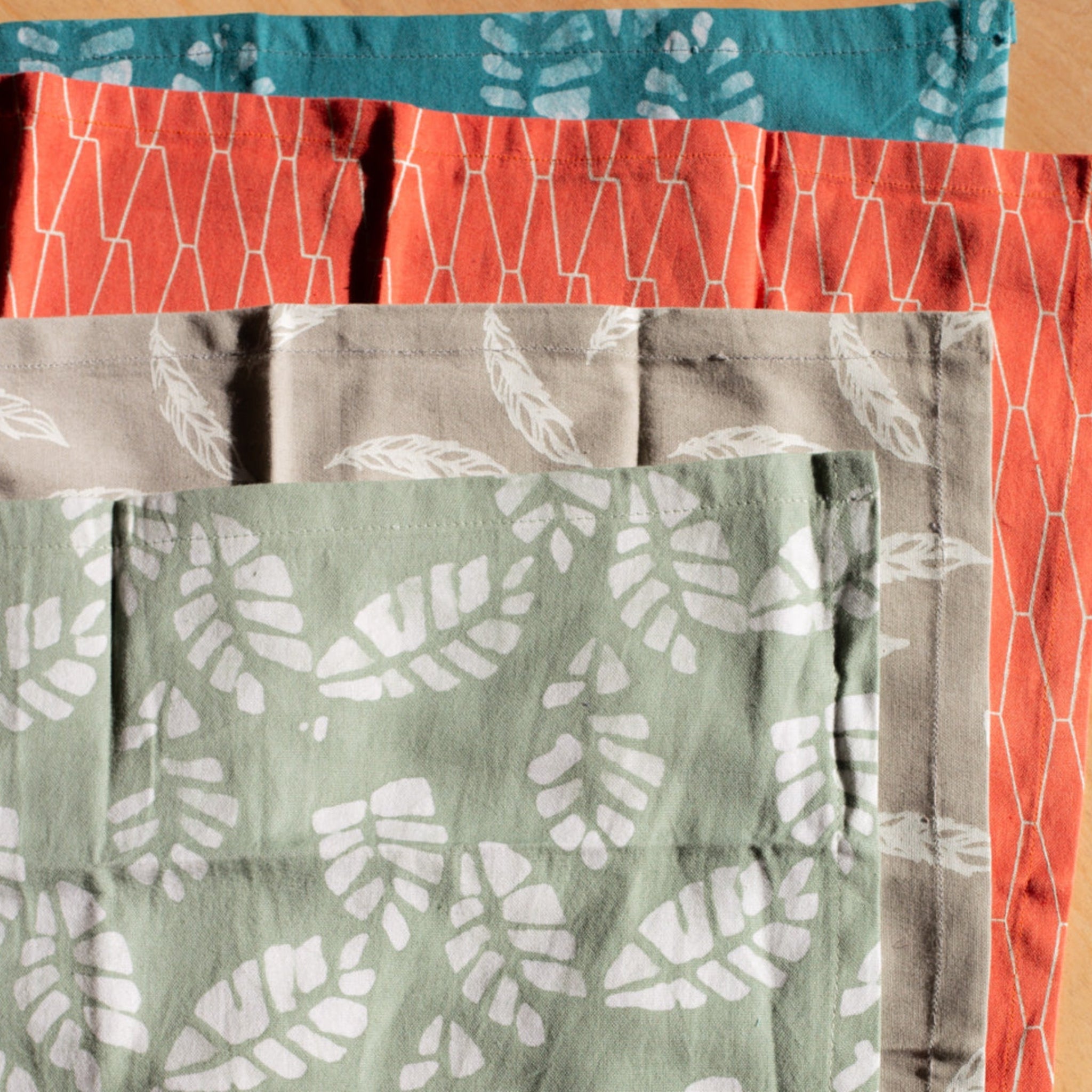 Multicolored napkins on a wood background.