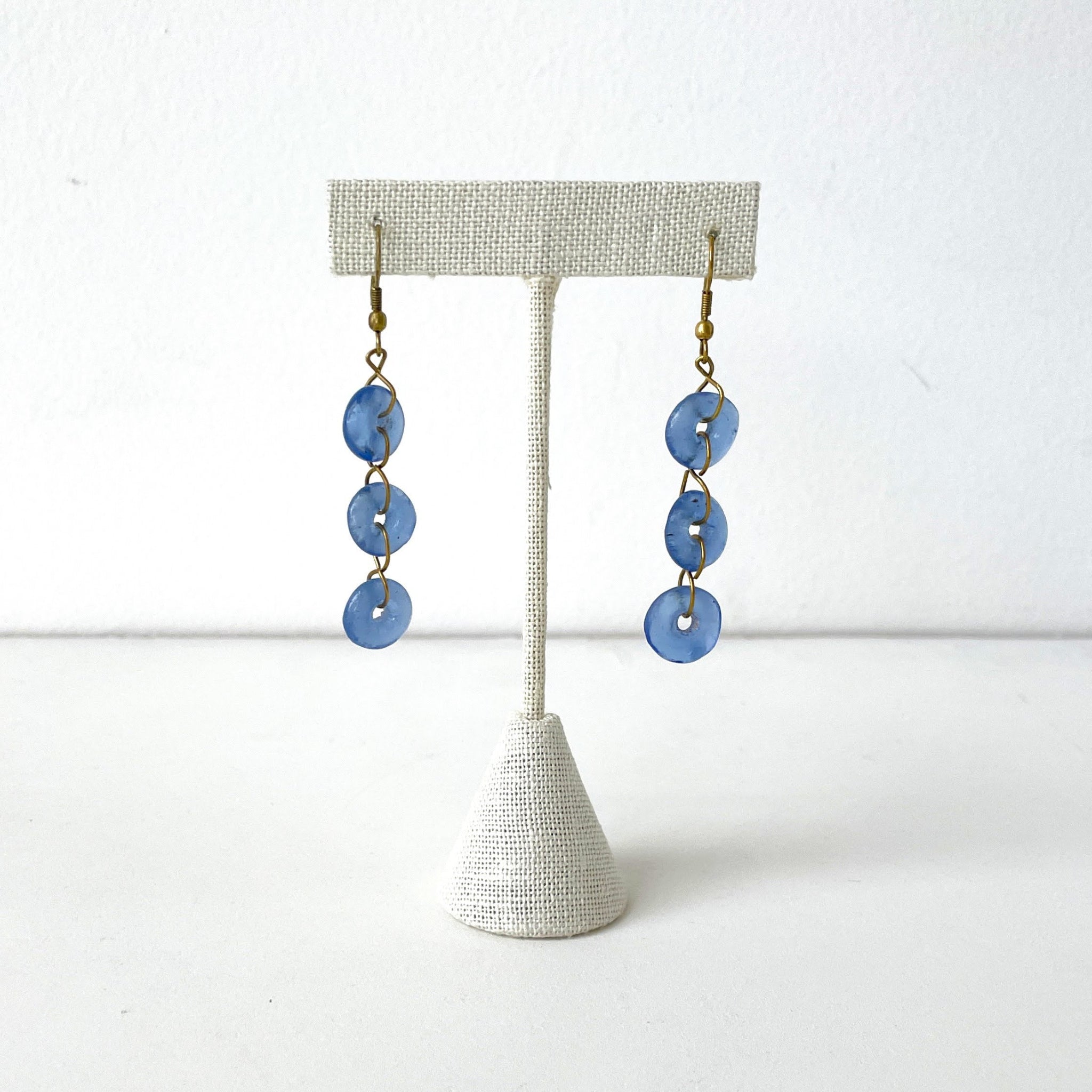 Pair of blue glass earrings on a white background