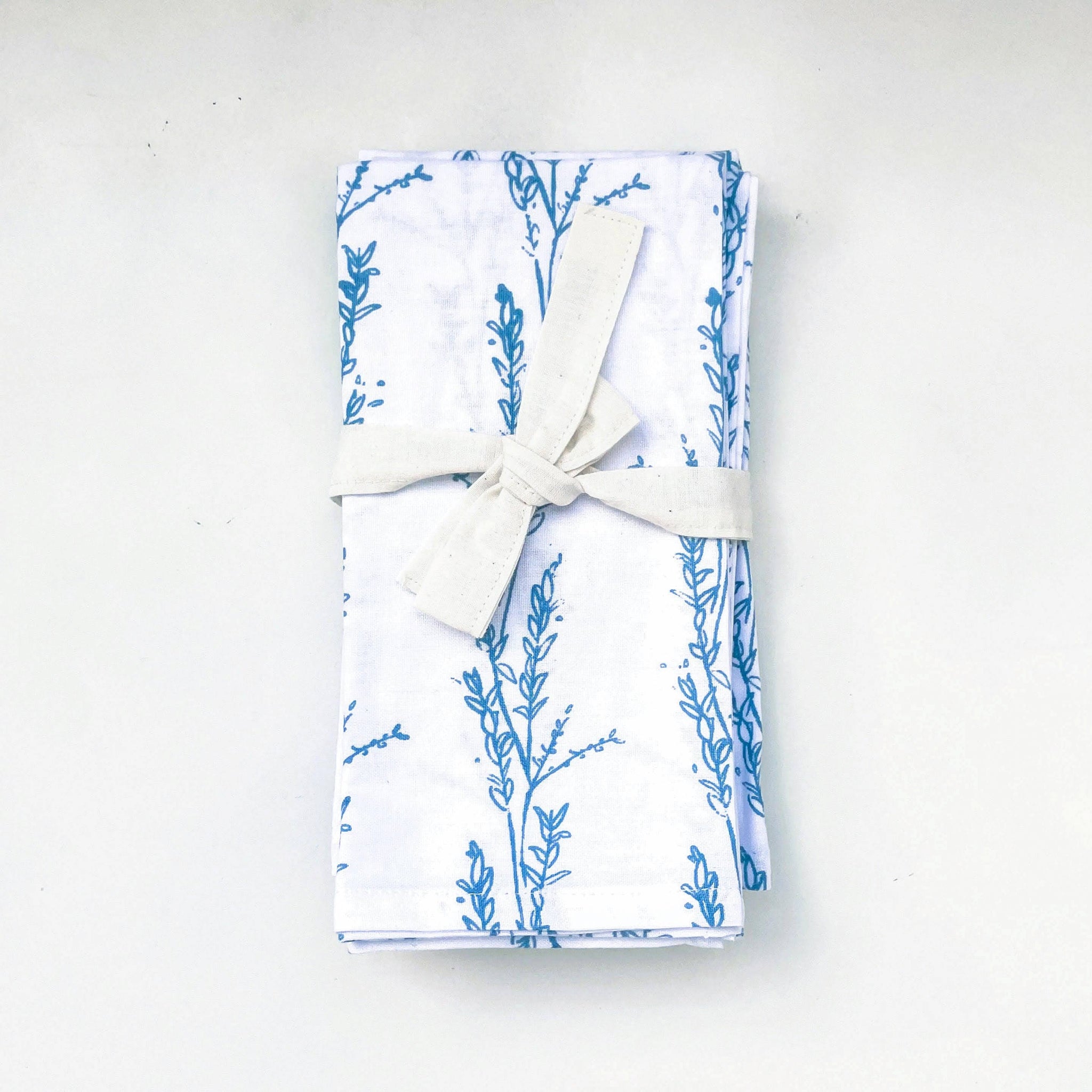 Folded fabric with blue floral pattern on a white background