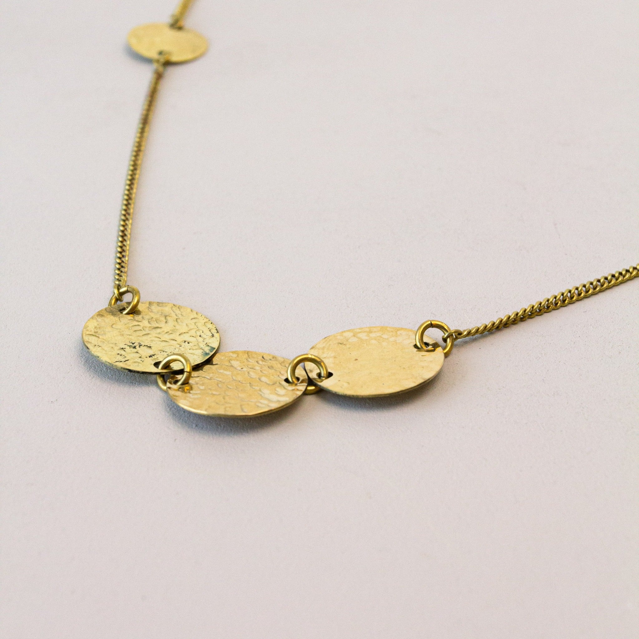 Brass necklace handmade by artisans from Nairobi, Kenya for a fair trade social enterprise