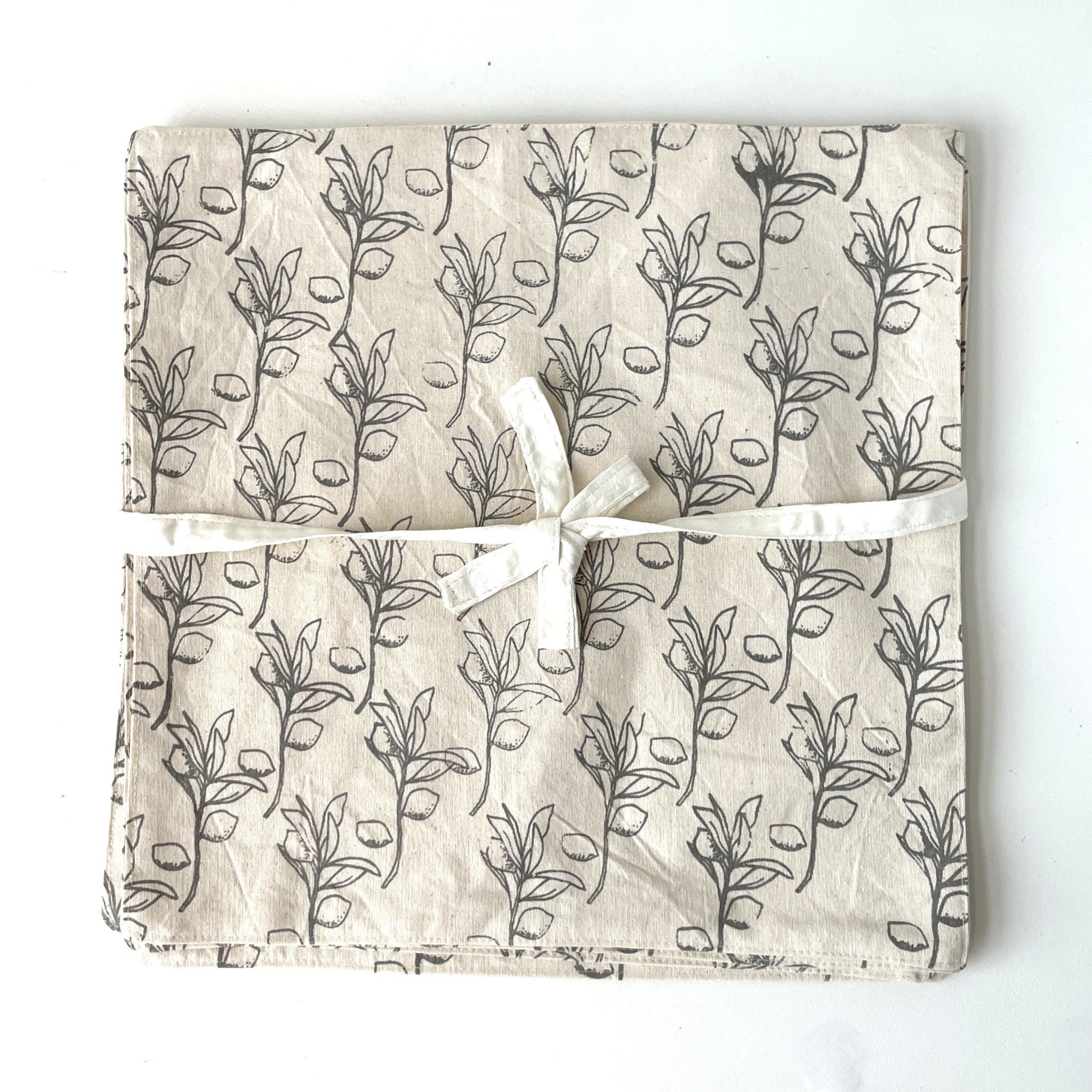 Lemon-patterned fabric with a white ribbon on a white background