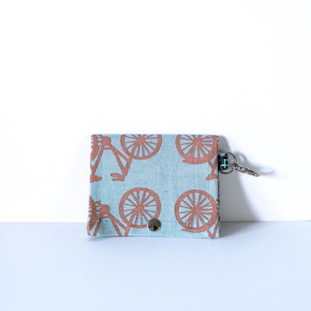 Blue ID wallet with tan bicycle print on a white background