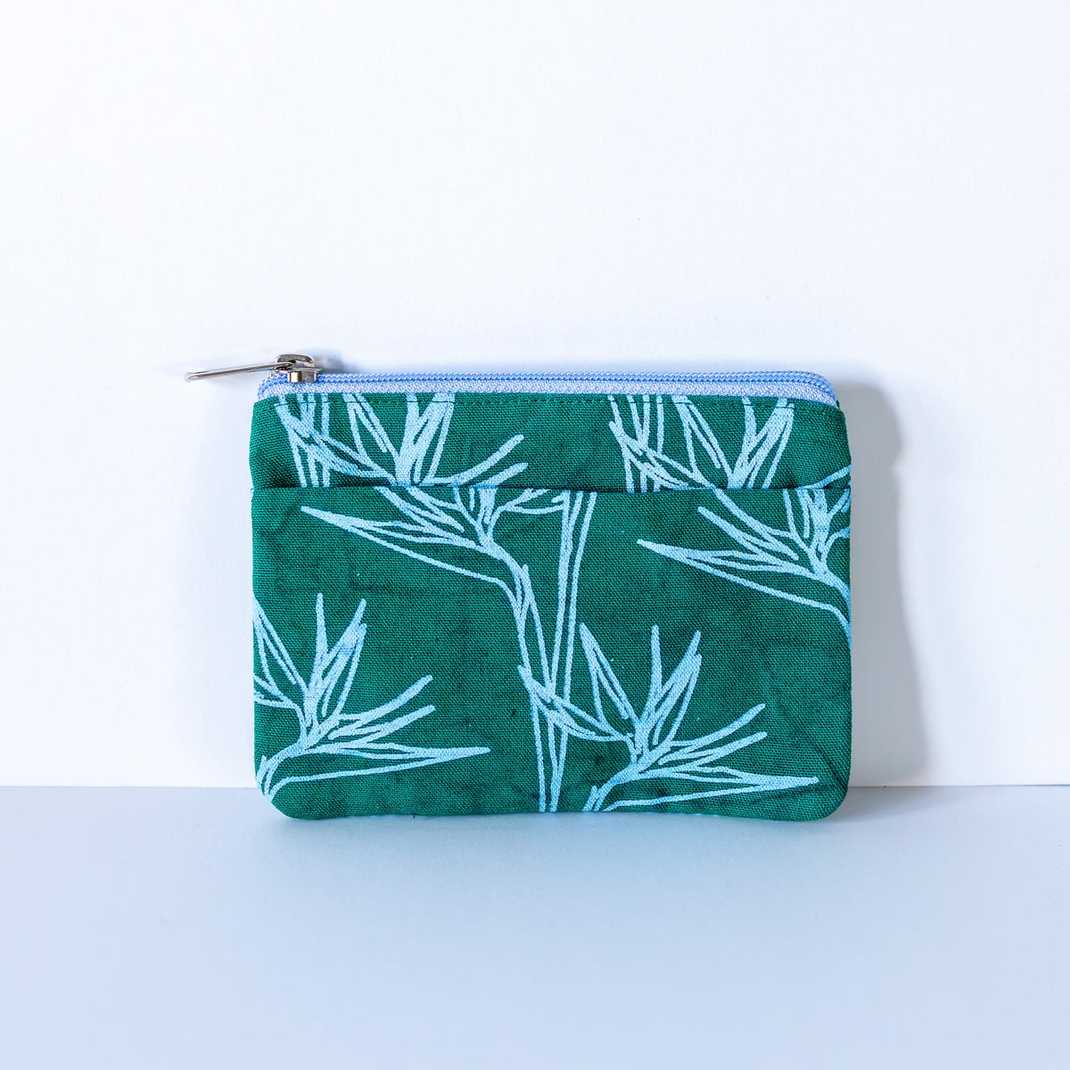 Green and pale blue coin purse on a white background