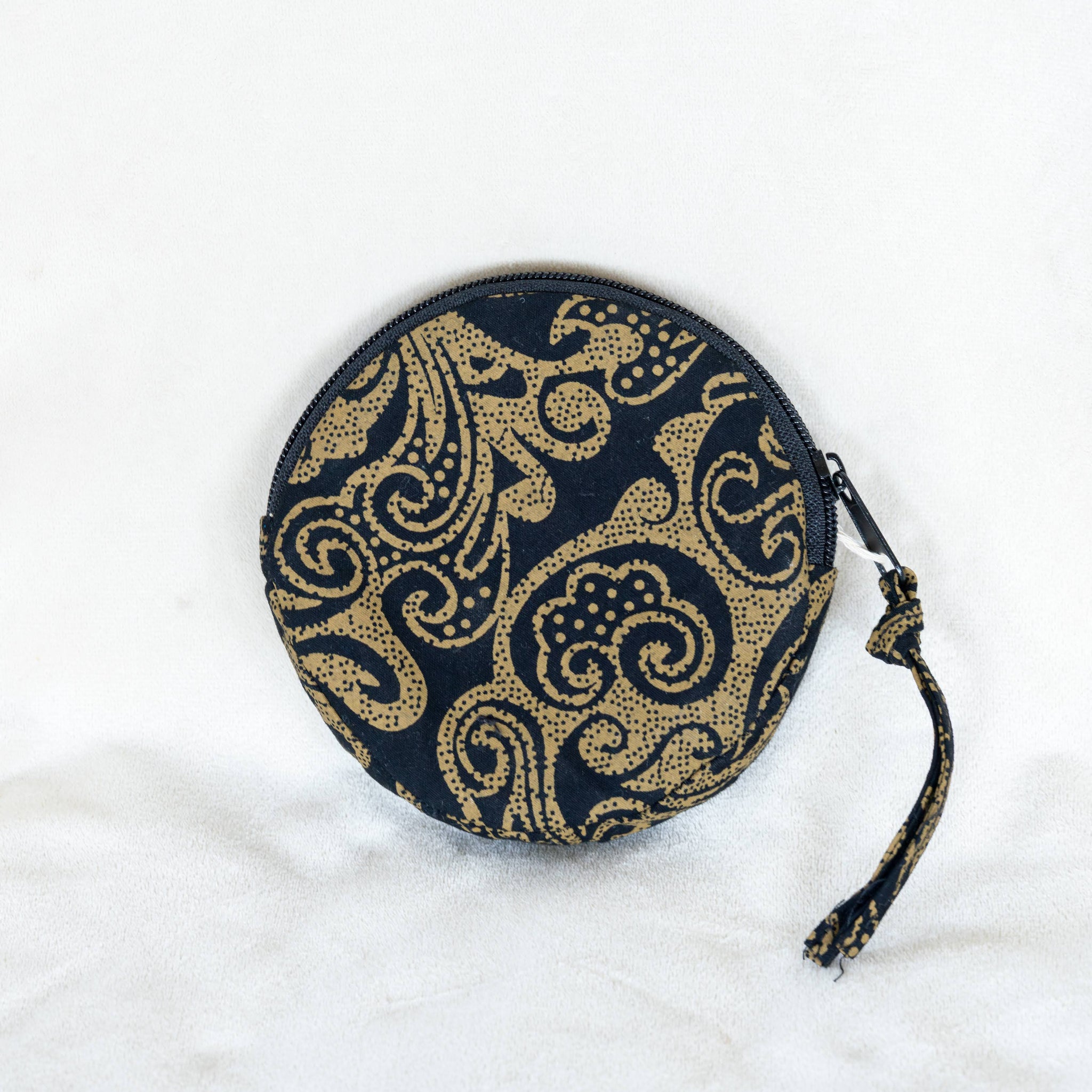 Black and gold round pouch on a white background