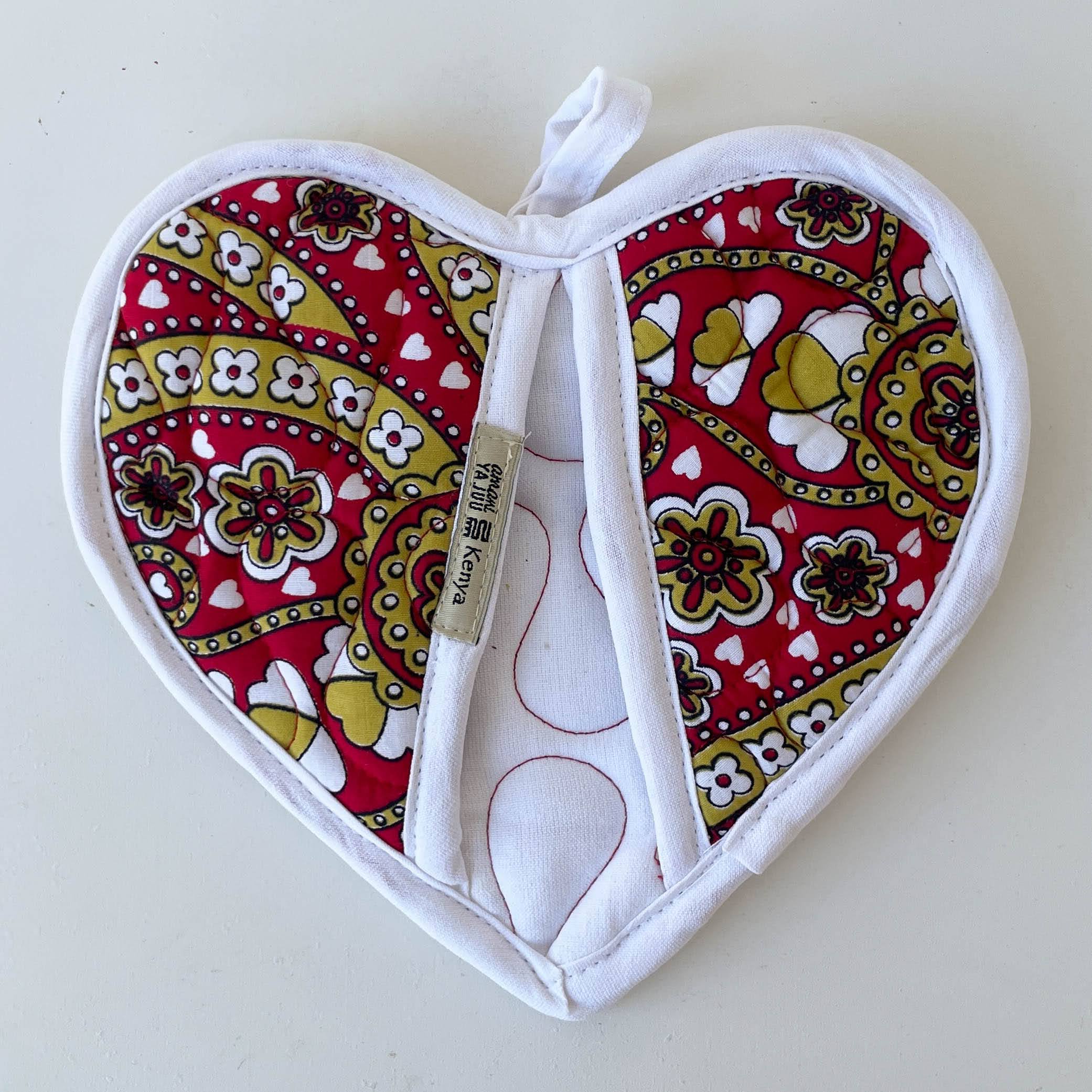 Heart-shaped pot holder with paisley pattern on a white background