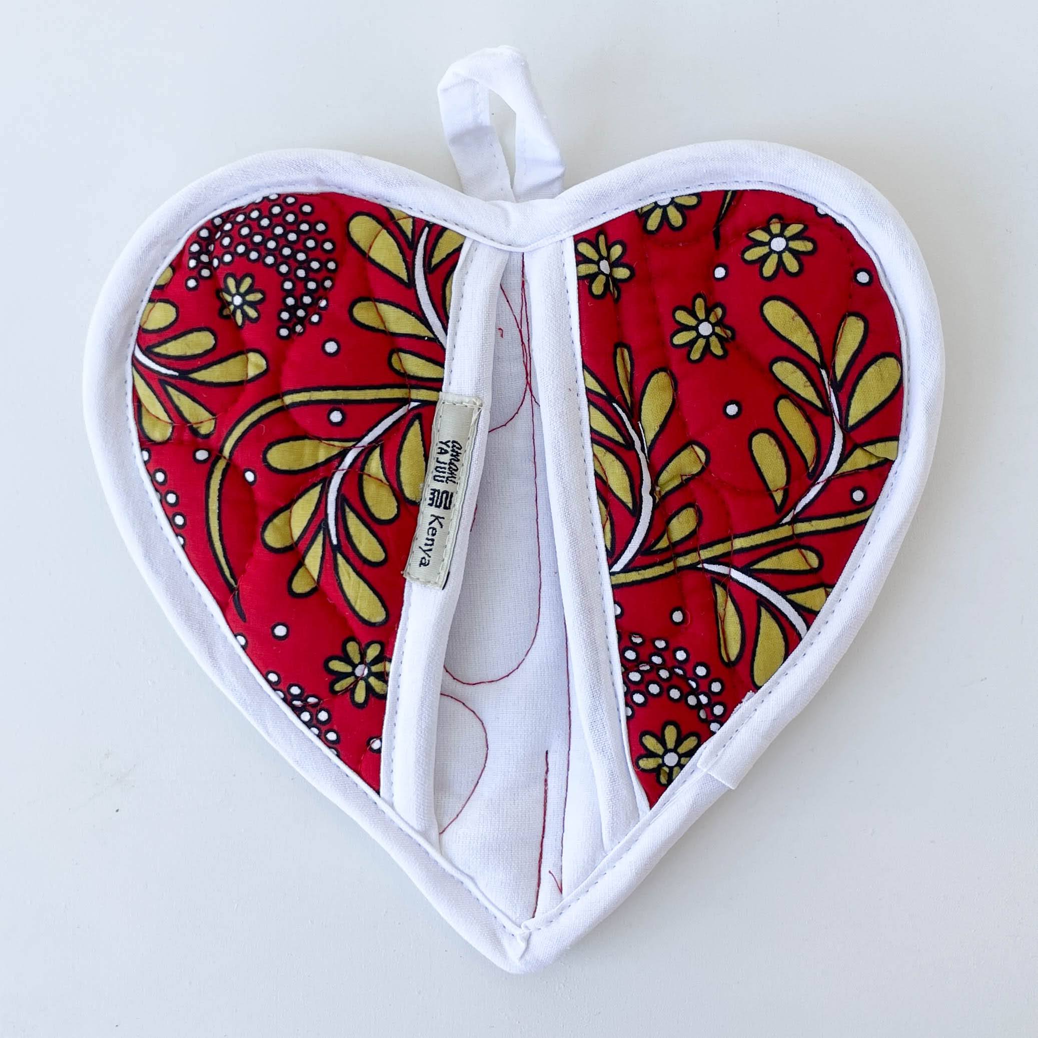 Heart-shaped pot holder with floral pattern on a white background