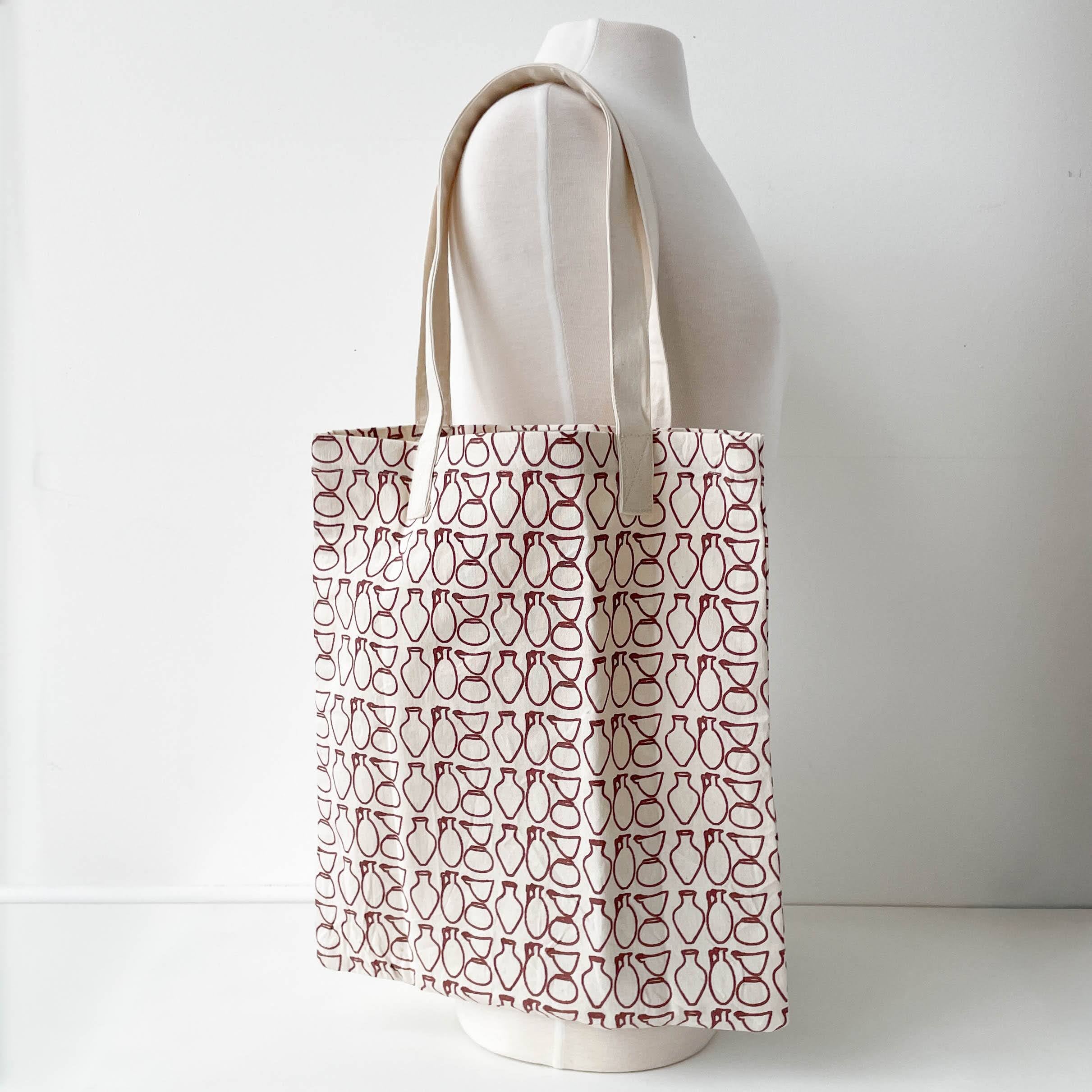 Tote bag with a pattern on a mannequin against a white background