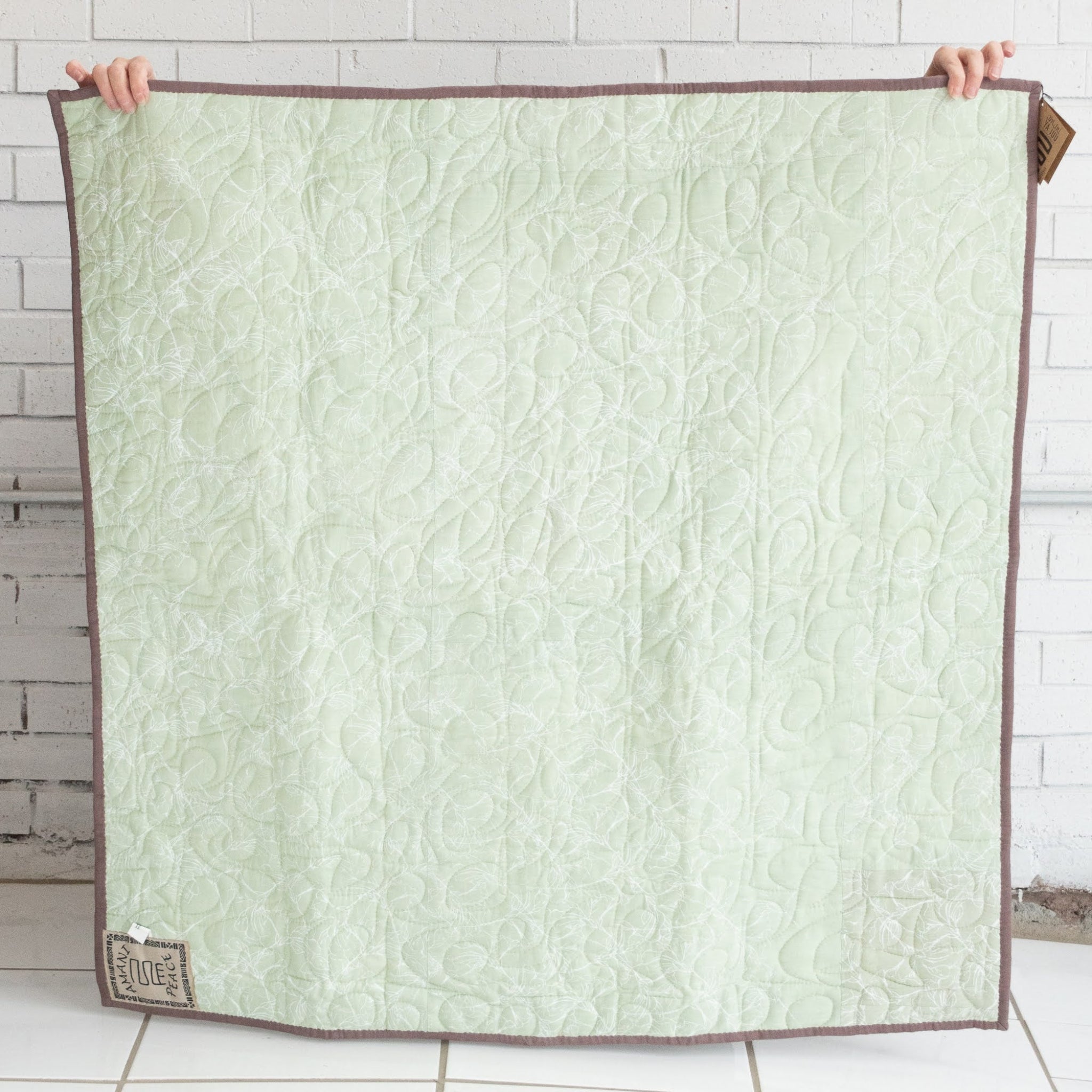 Hand stitched, hand dyed fabrics pieced together for an Amani ya Juu baby quilt