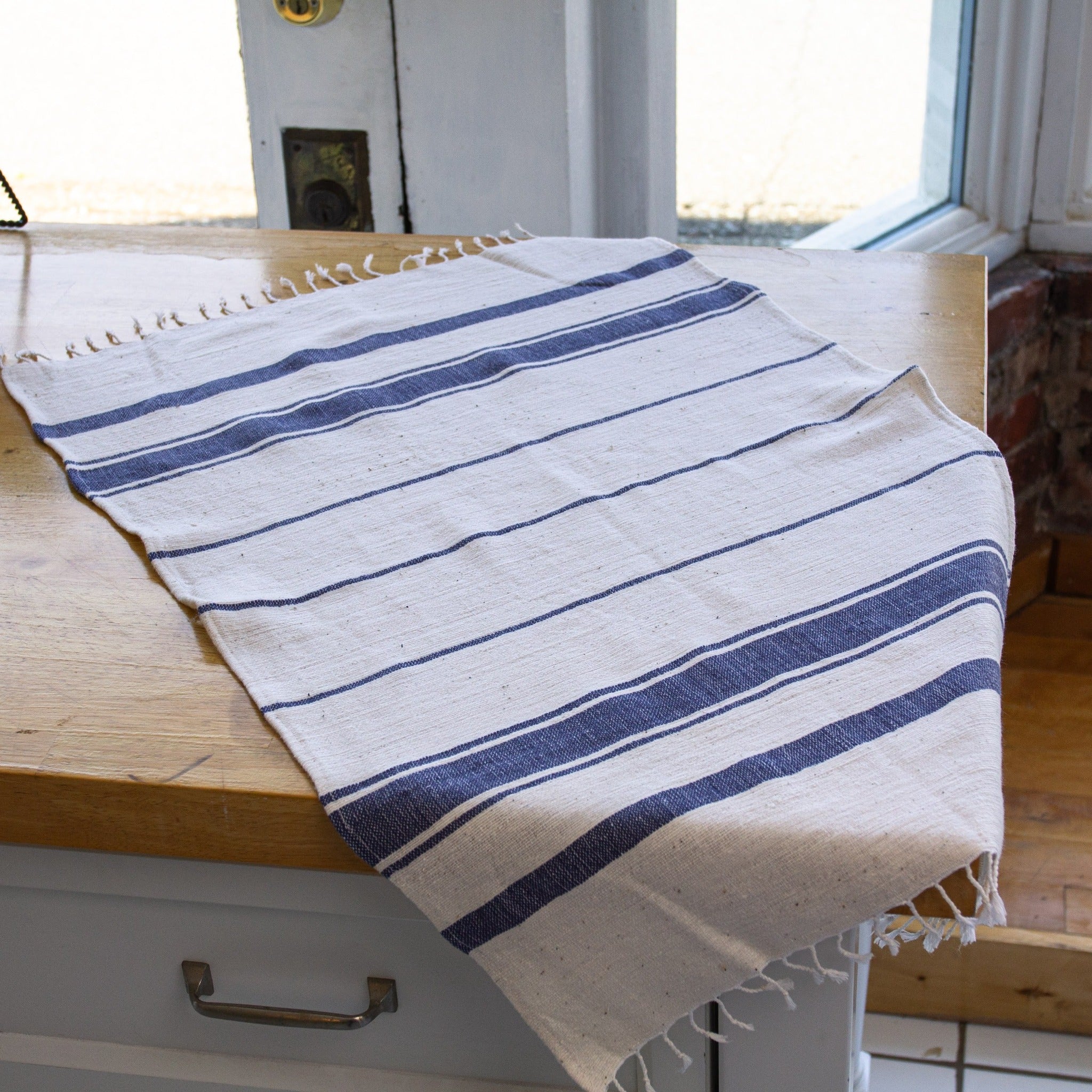 Ethiopian Woven Dish Towel - hand-crafted in Ethiopia using African fabrics and materials- made for a fair trade Etched Leaf Earrings- made for a fair trade social enterprise