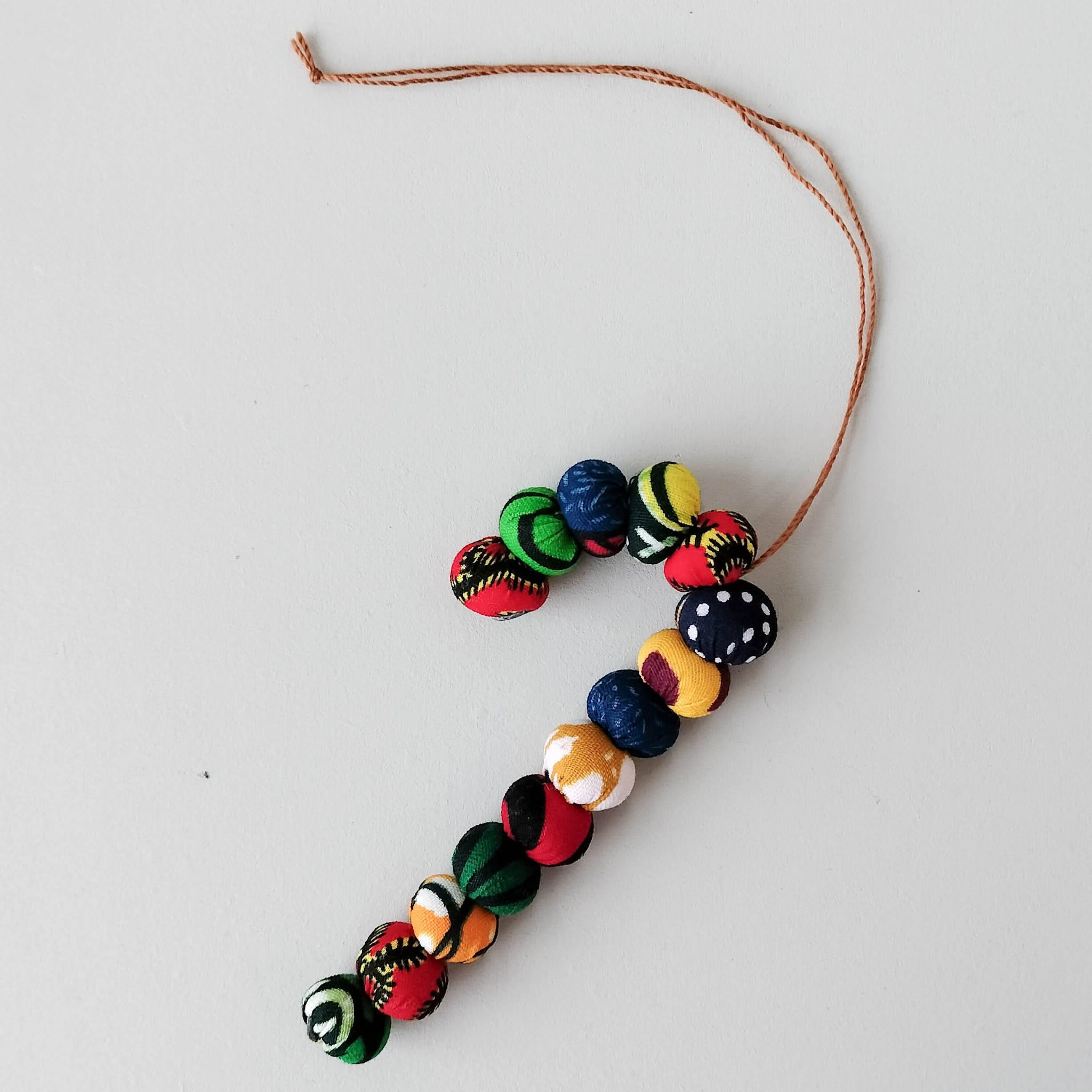 Kitenge ball candy cane ornament - handmade using local kitenge fabric by the Amani women of Uganda for a social enterprise