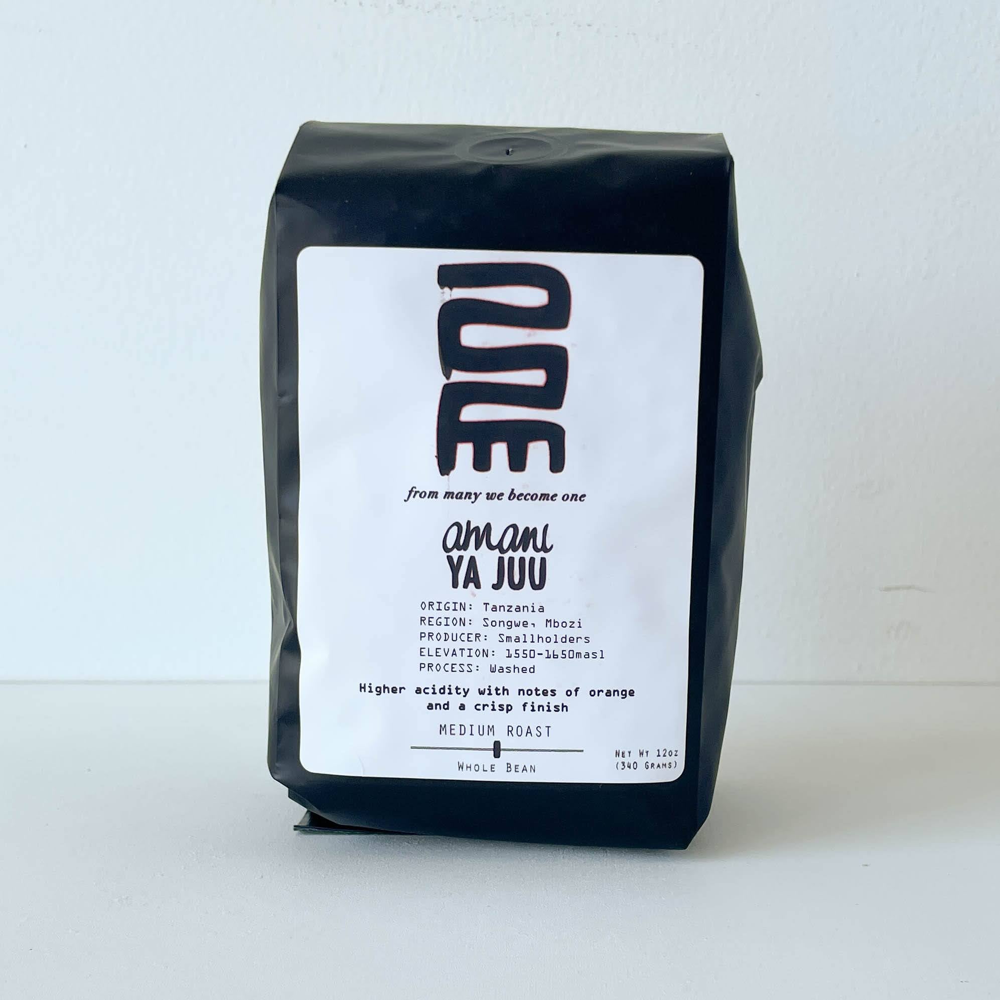 Black coffee bag with a white label on a light gray background