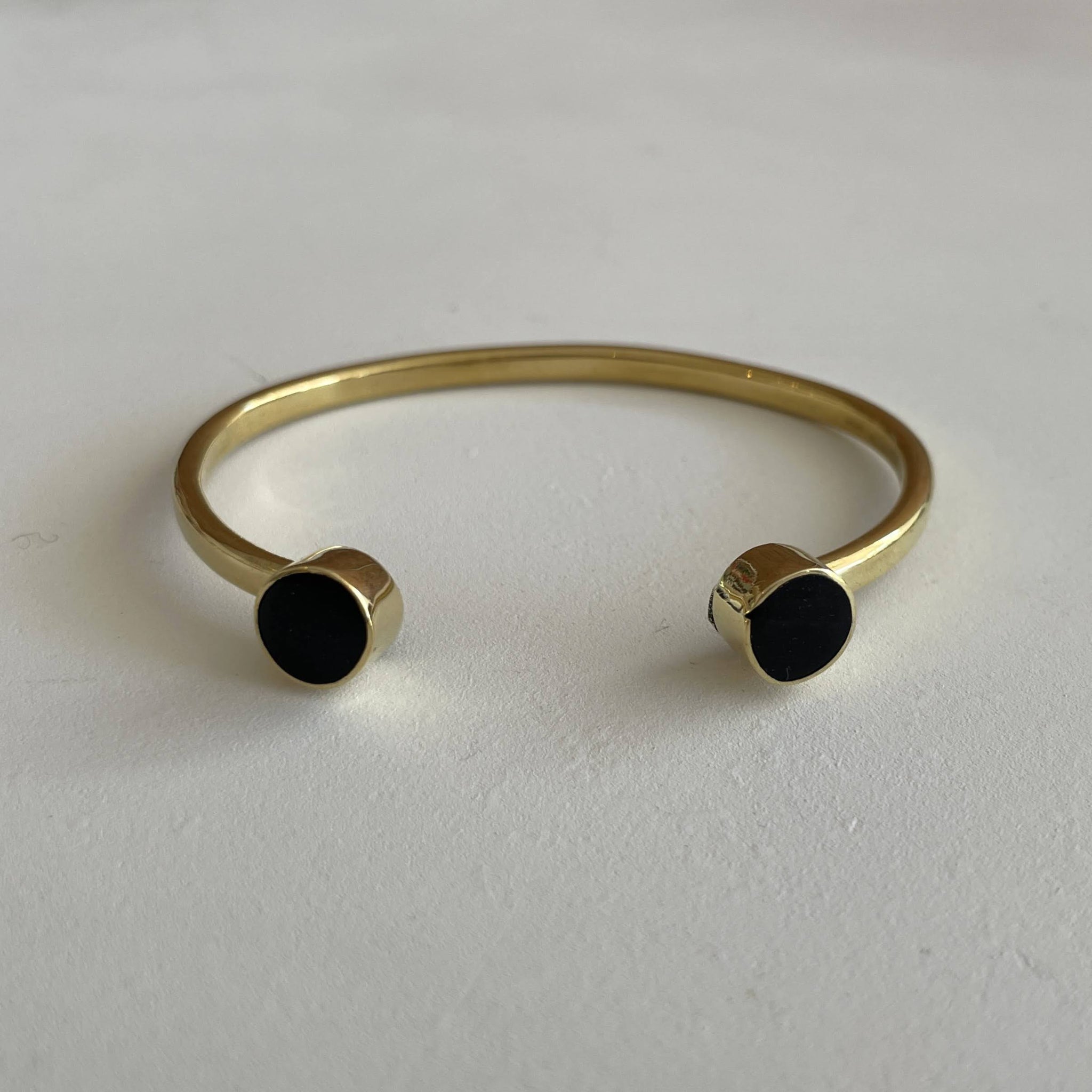 Brass bracelet with black horn on a white background
