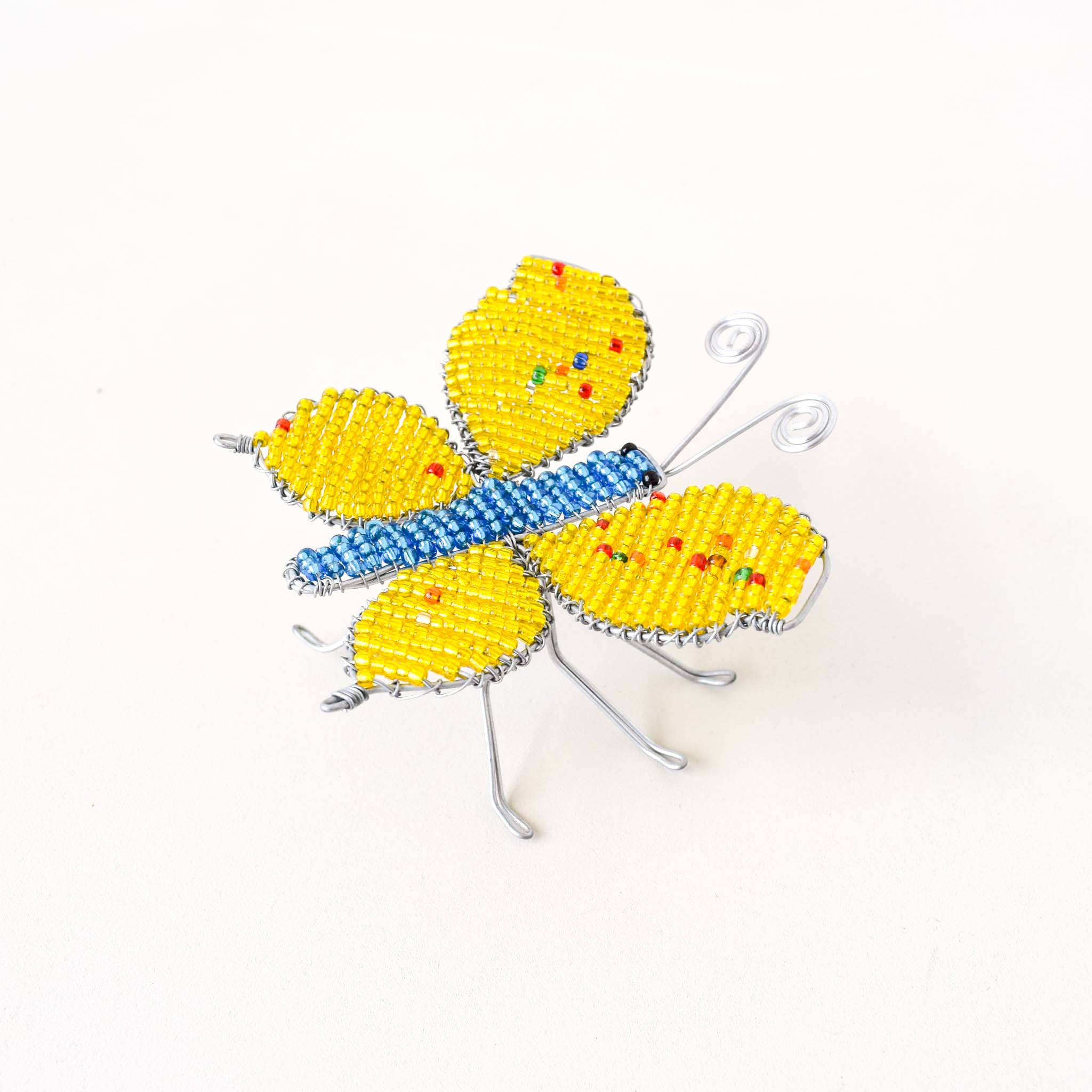 Butterfly-shaped object made of beads on a white background