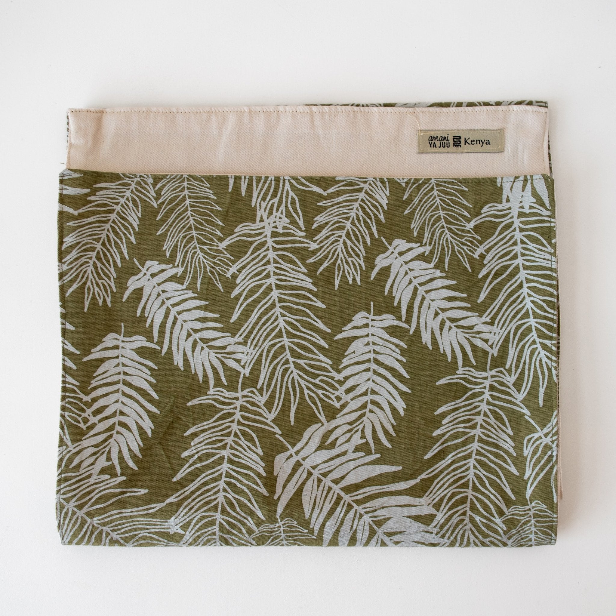 Folded sage green and white fern table runner on white background