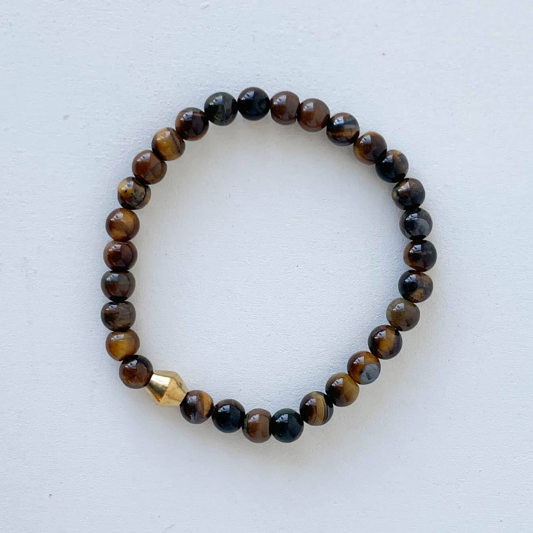 Beaded bracelet with brown and black beads on a white background