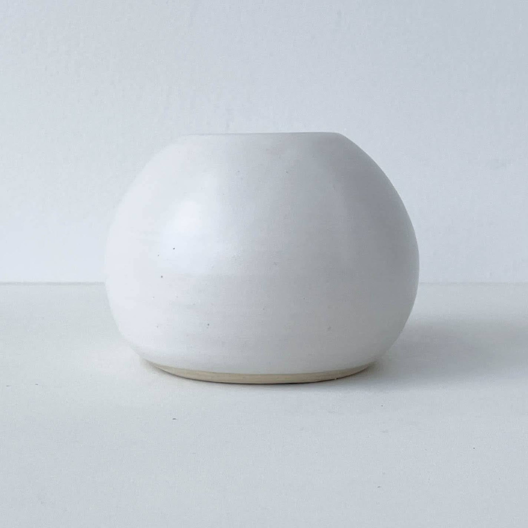 White ceramic vase on a light gray background