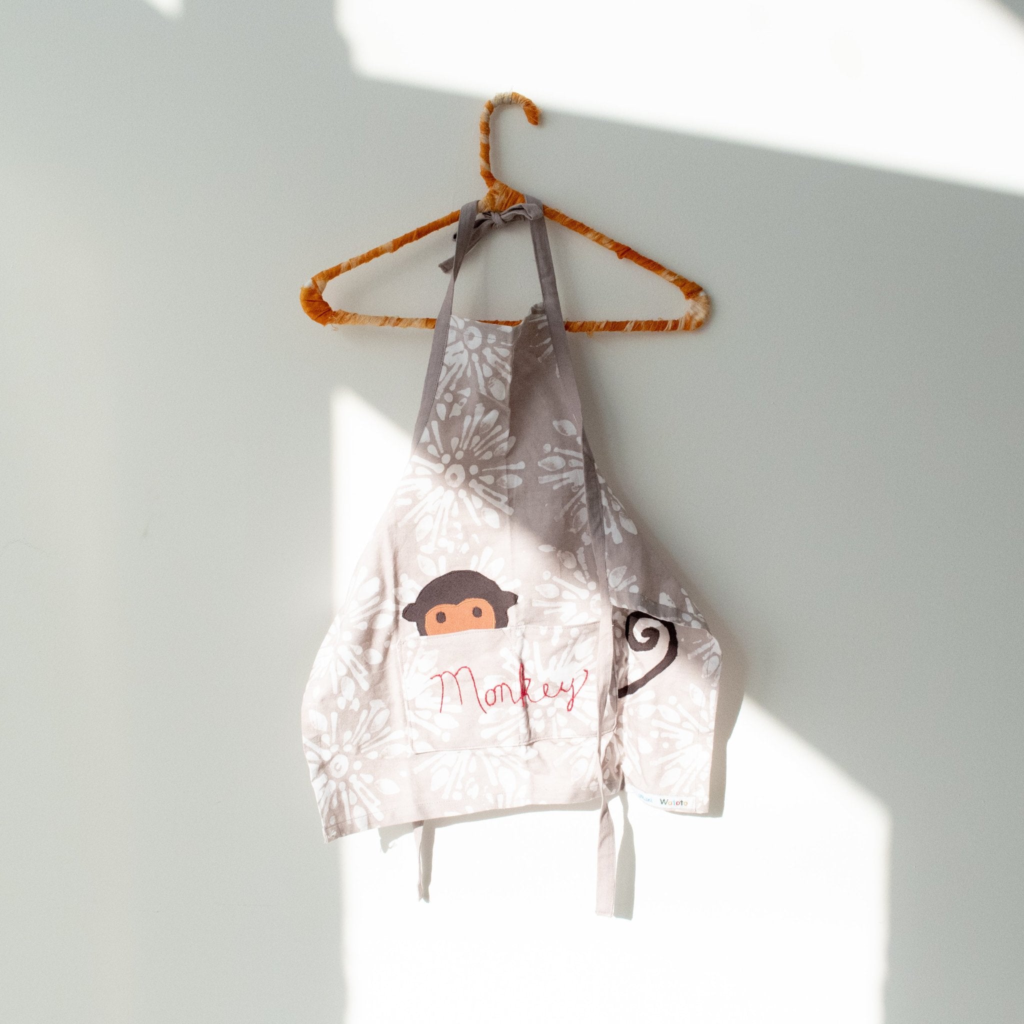 Watoto play apron - Original batik design handmade by the women of Amani ya Juu a Fair Trade social enterprise