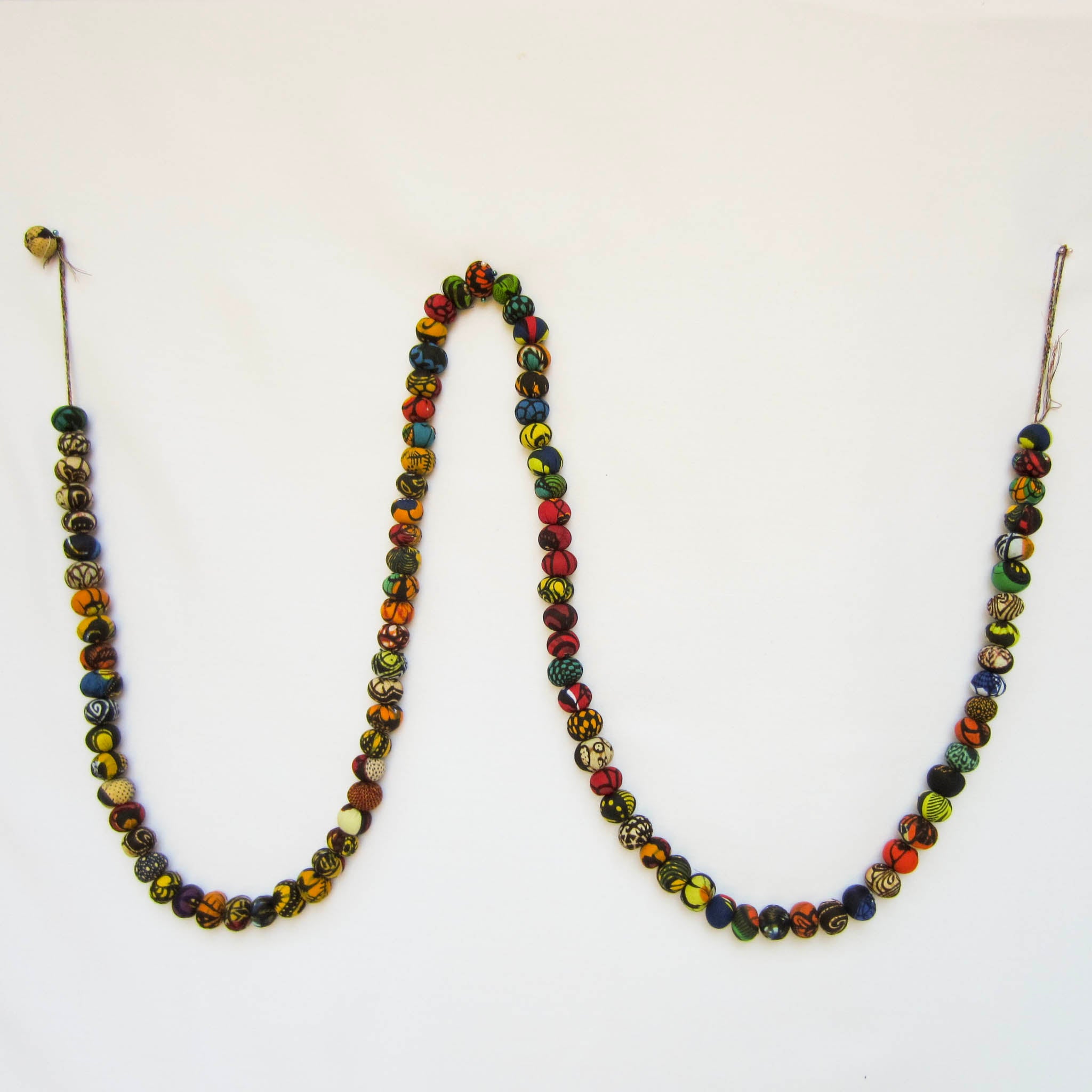 Kitenge ball garland - handmade using local kitenge fabric by the Amani women of Uganda for a fair trade social enterprise