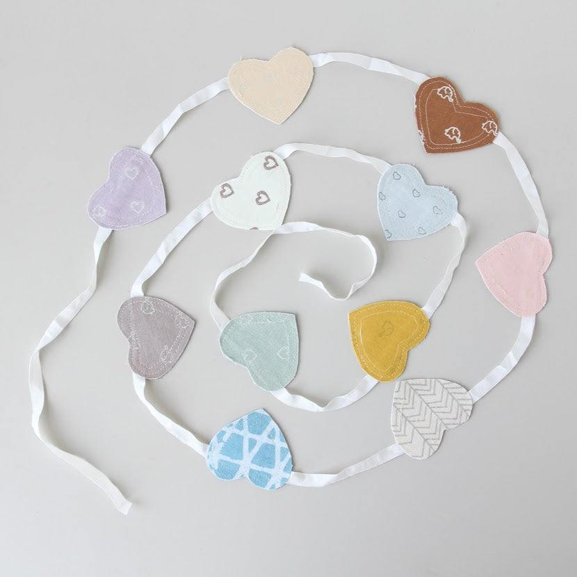 Screen printed hearts strung together on a ribbon from Amani ya Juu Kenya, a fair trade organization employing women in Africa