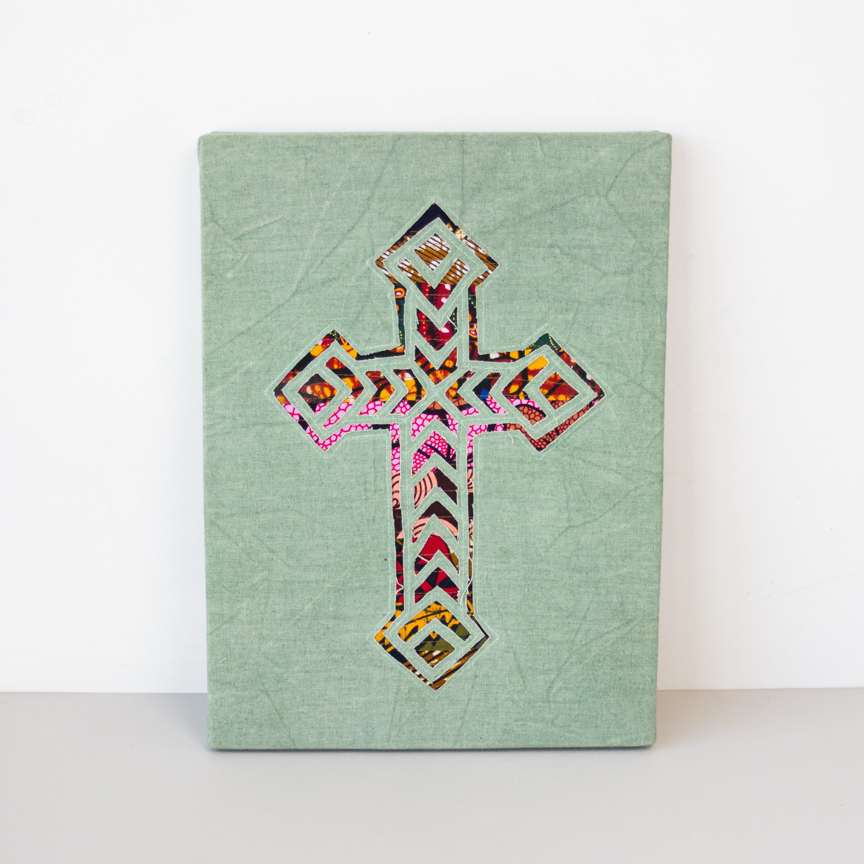 Cross wall hanging hand made from African fabrics, from Amani ya Juu in Kenya, a fair trade socio-economic sewing program for refugee women