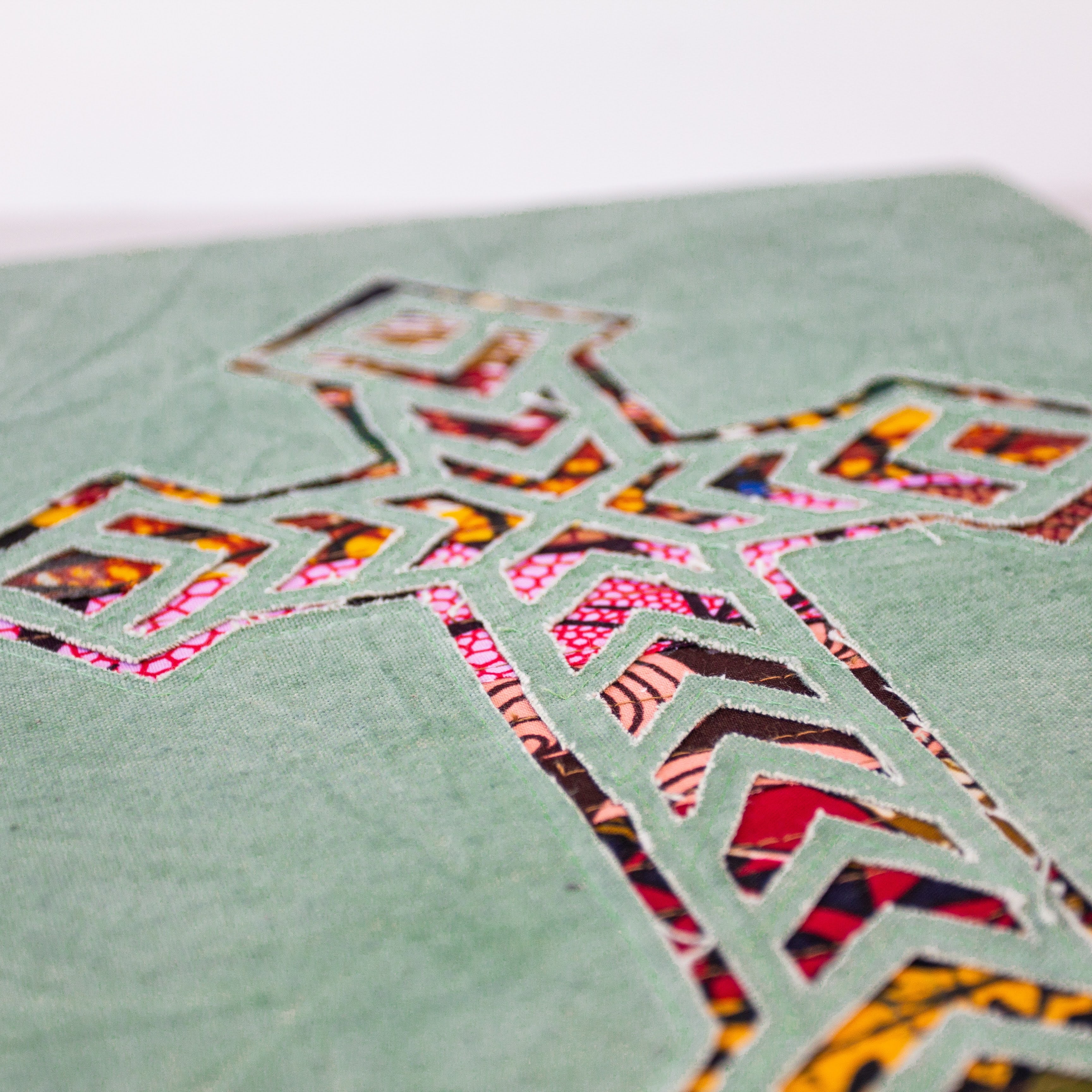Cross wall hanging hand made from African fabrics, from Amani ya Juu in Kenya, a fair trade socio-economic sewing program for refugee women