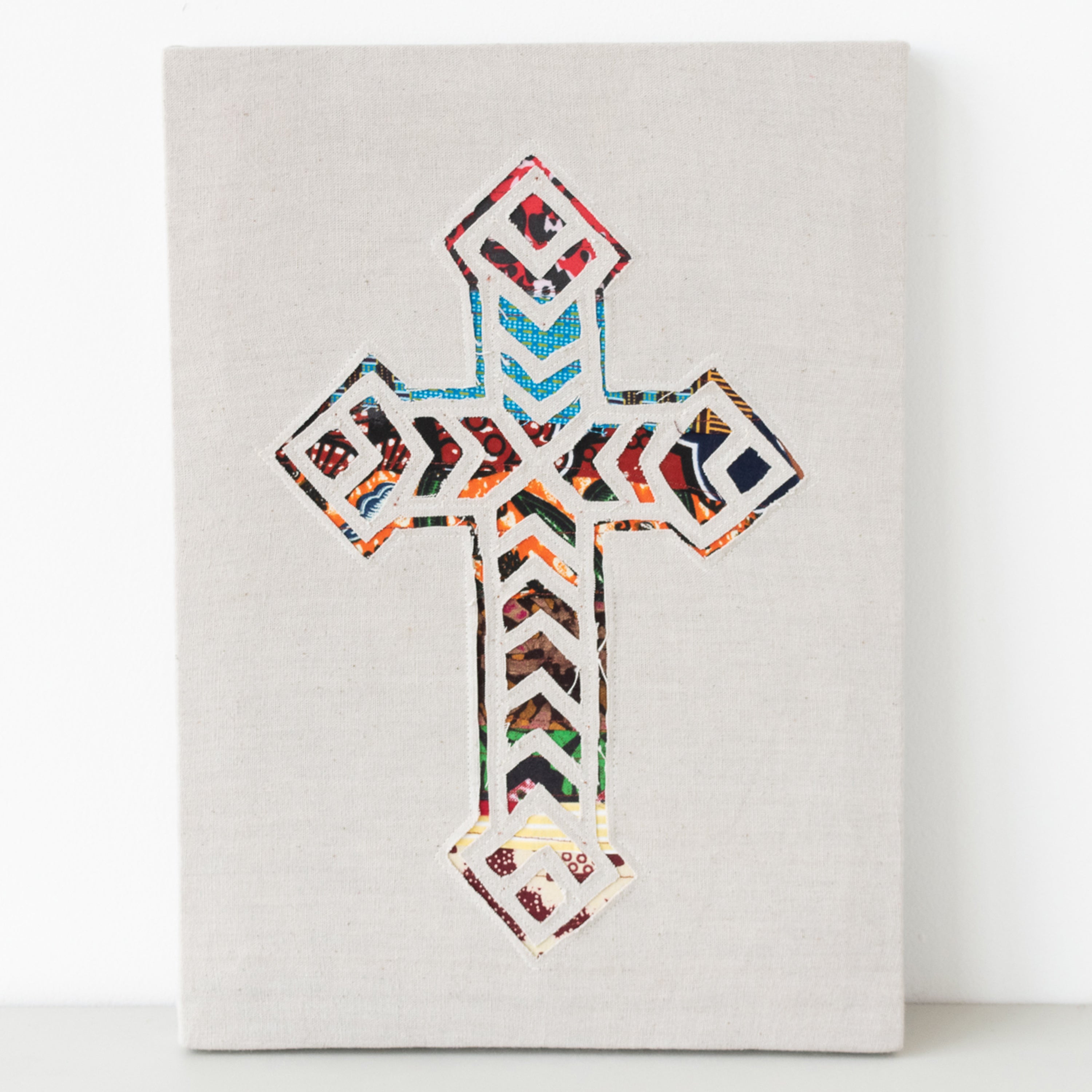 Cross wall hanging hand made from African fabrics, from Amani ya Juu in Kenya, a fair trade socio-economic sewing program for refugee women