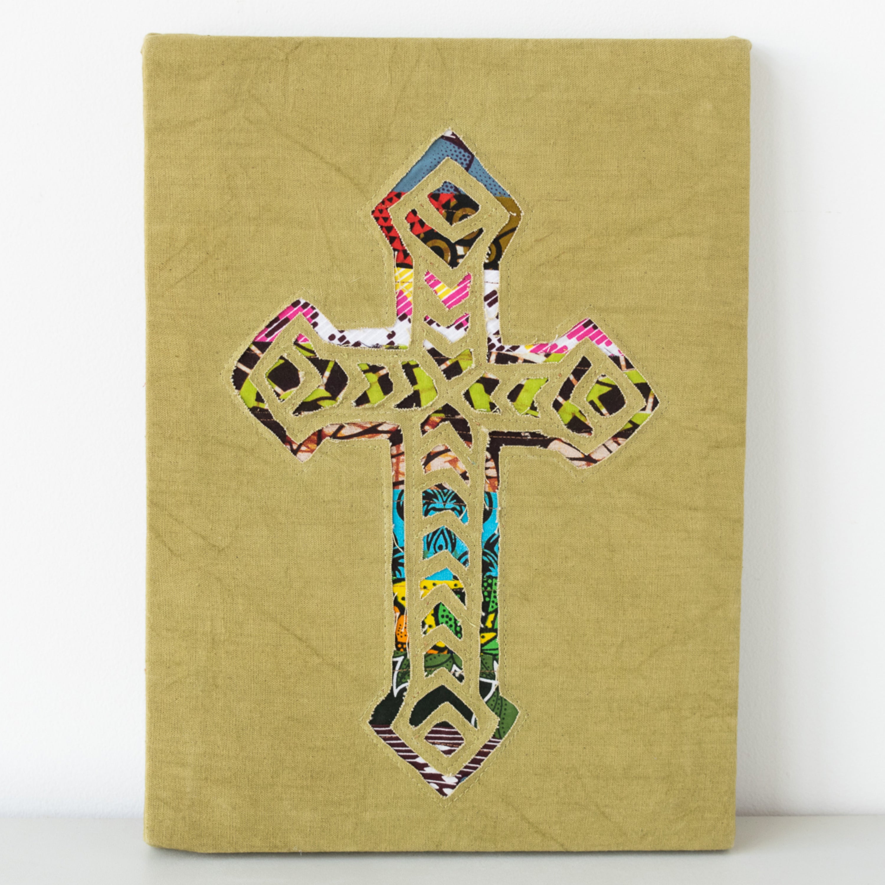 Cross wall hanging hand made from African fabrics, from Amani ya Juu in Kenya, a fair trade socio-economic sewing program