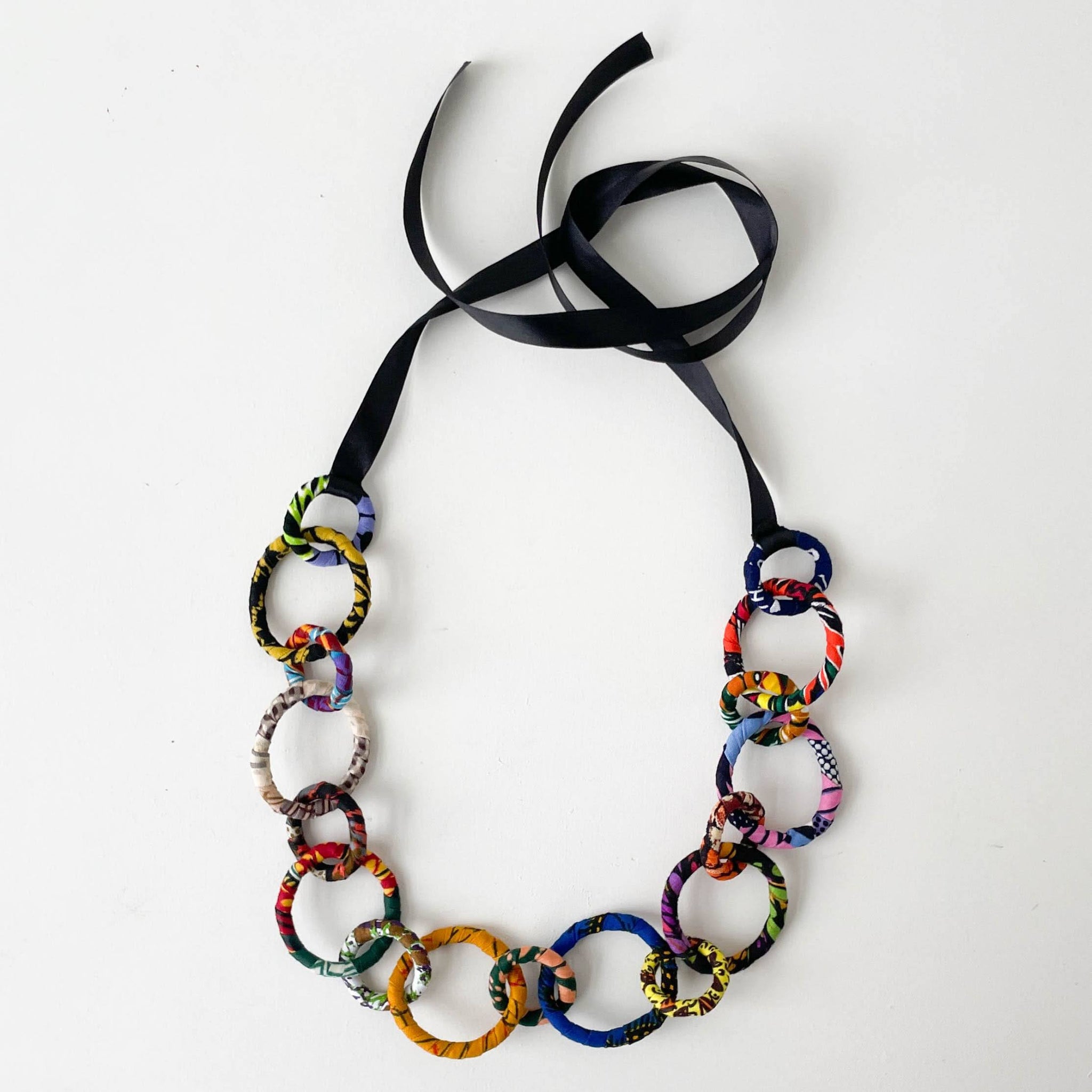 Colorful chain necklace with a black ribbon on a white background