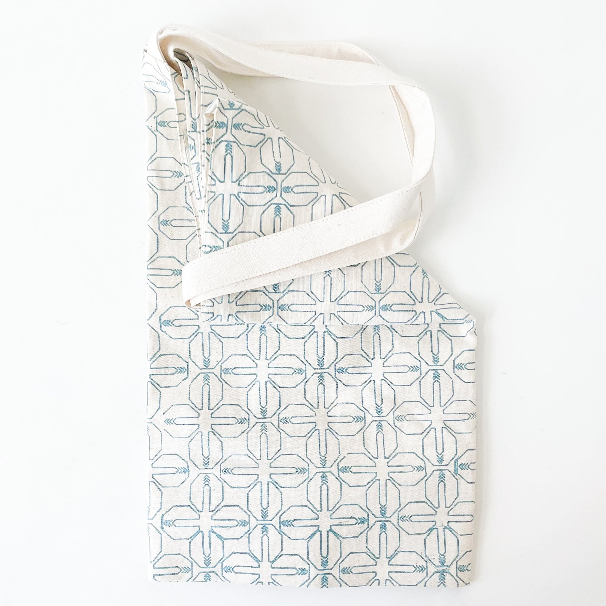 Patterned bag with a white strap on a white background