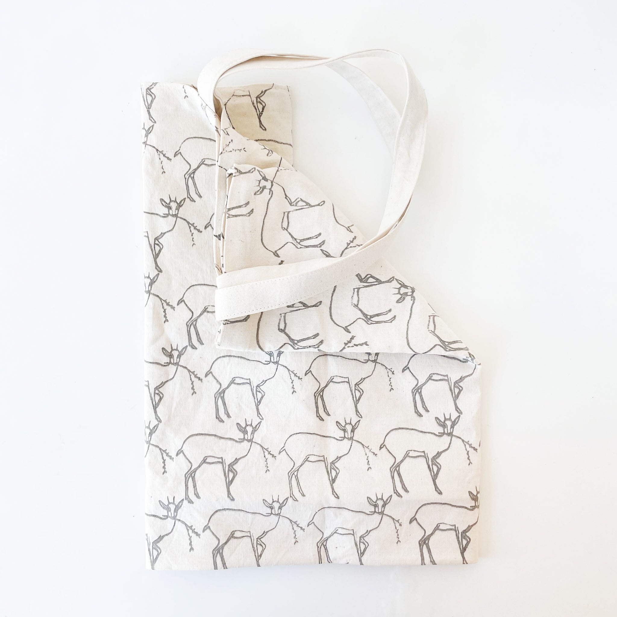 White tote with deer pattern on a white background