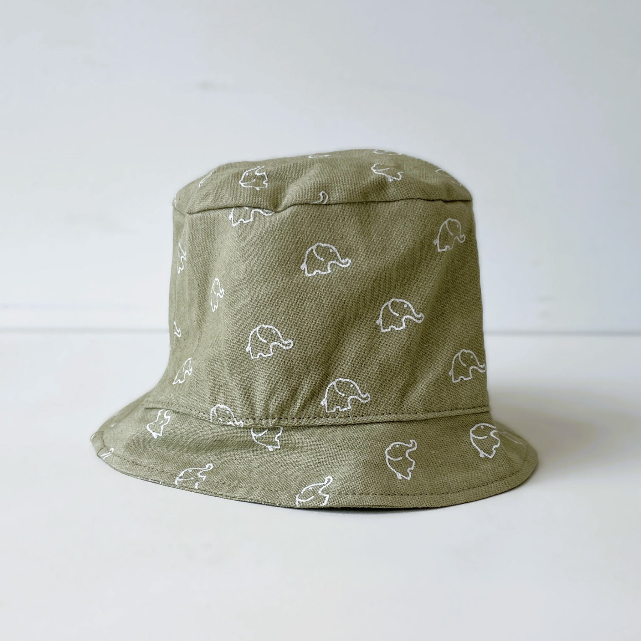 Grey bucket hat with white elephant patterns on a white background