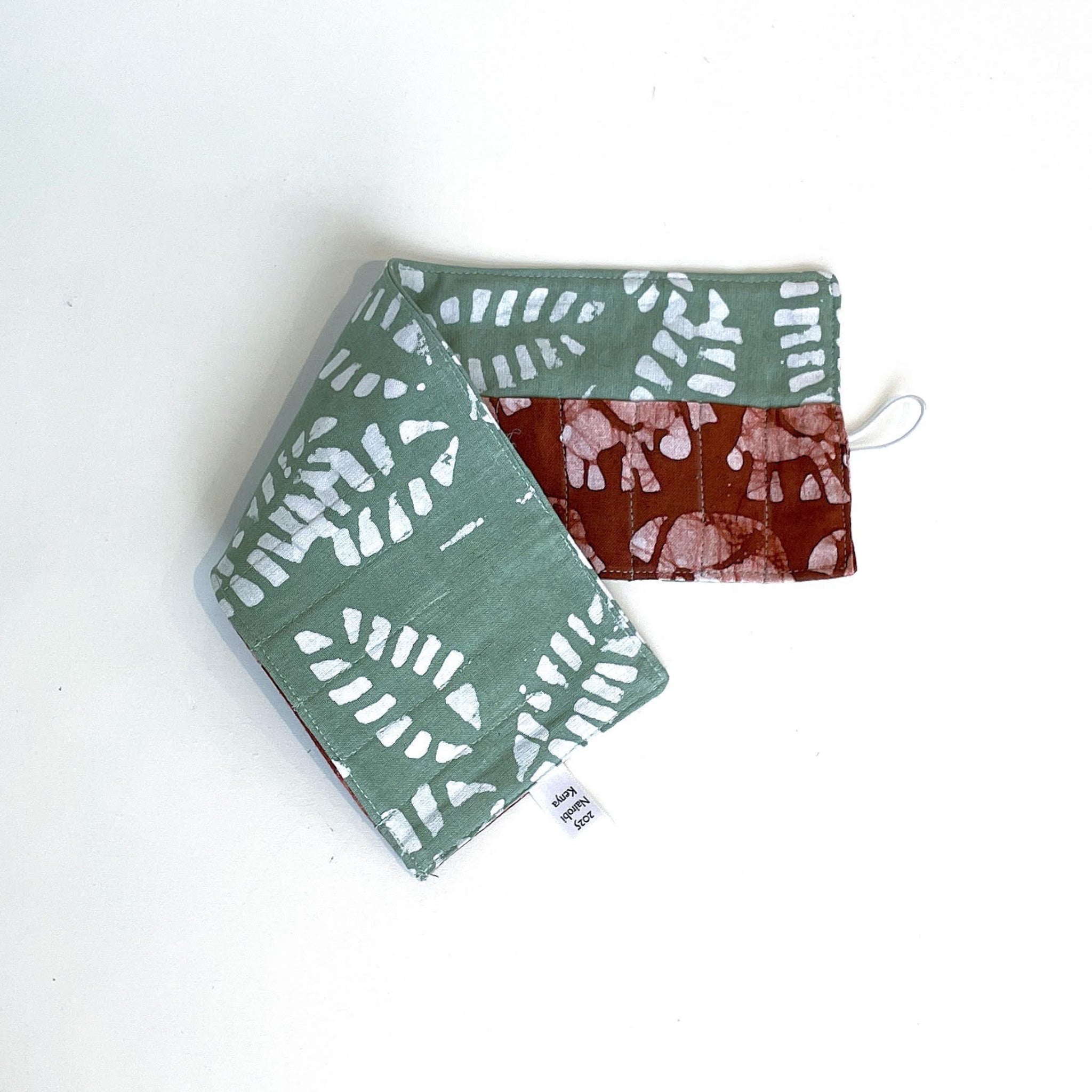 Two fabric crayon holder with patterns on a white background