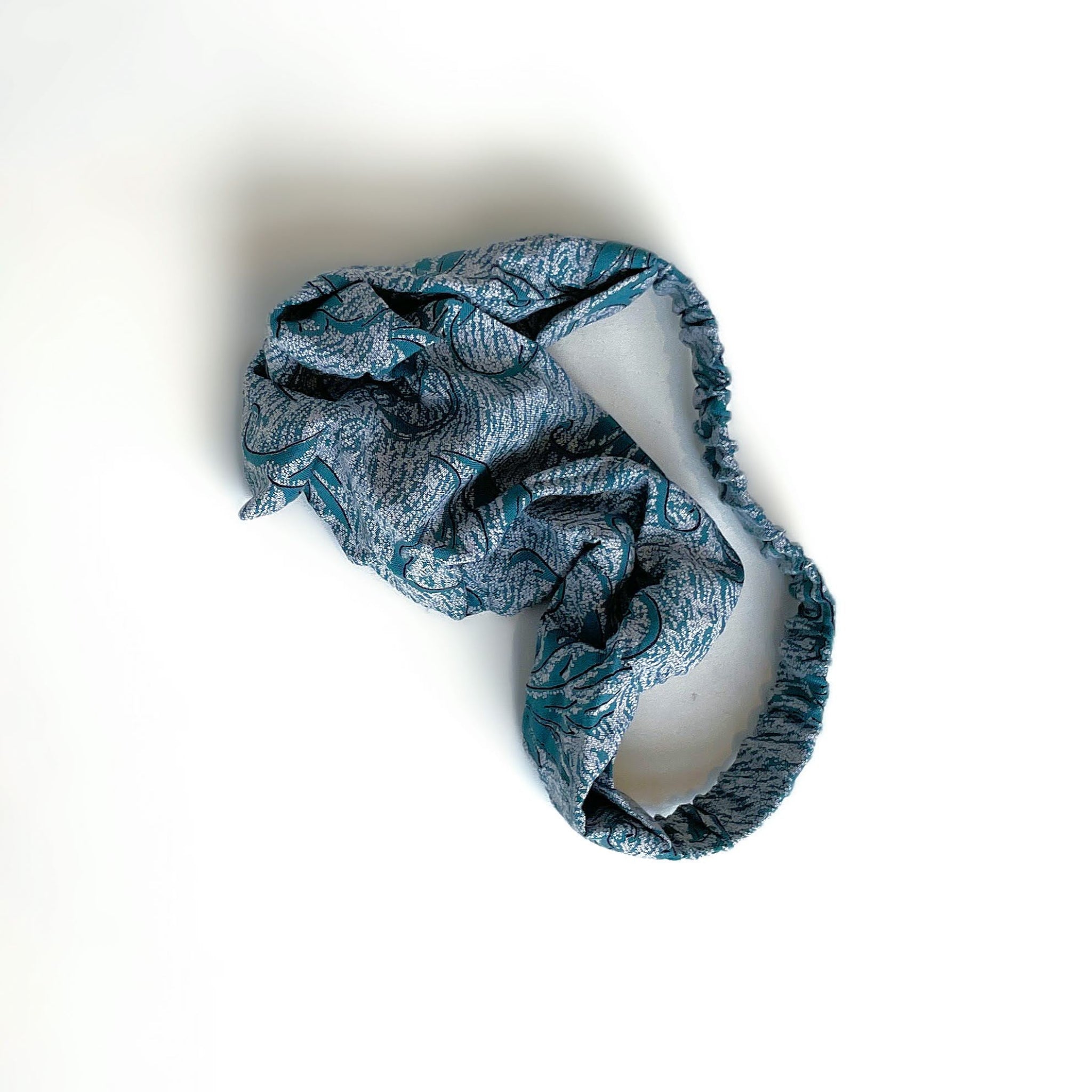 Blue patterned headband on a white background