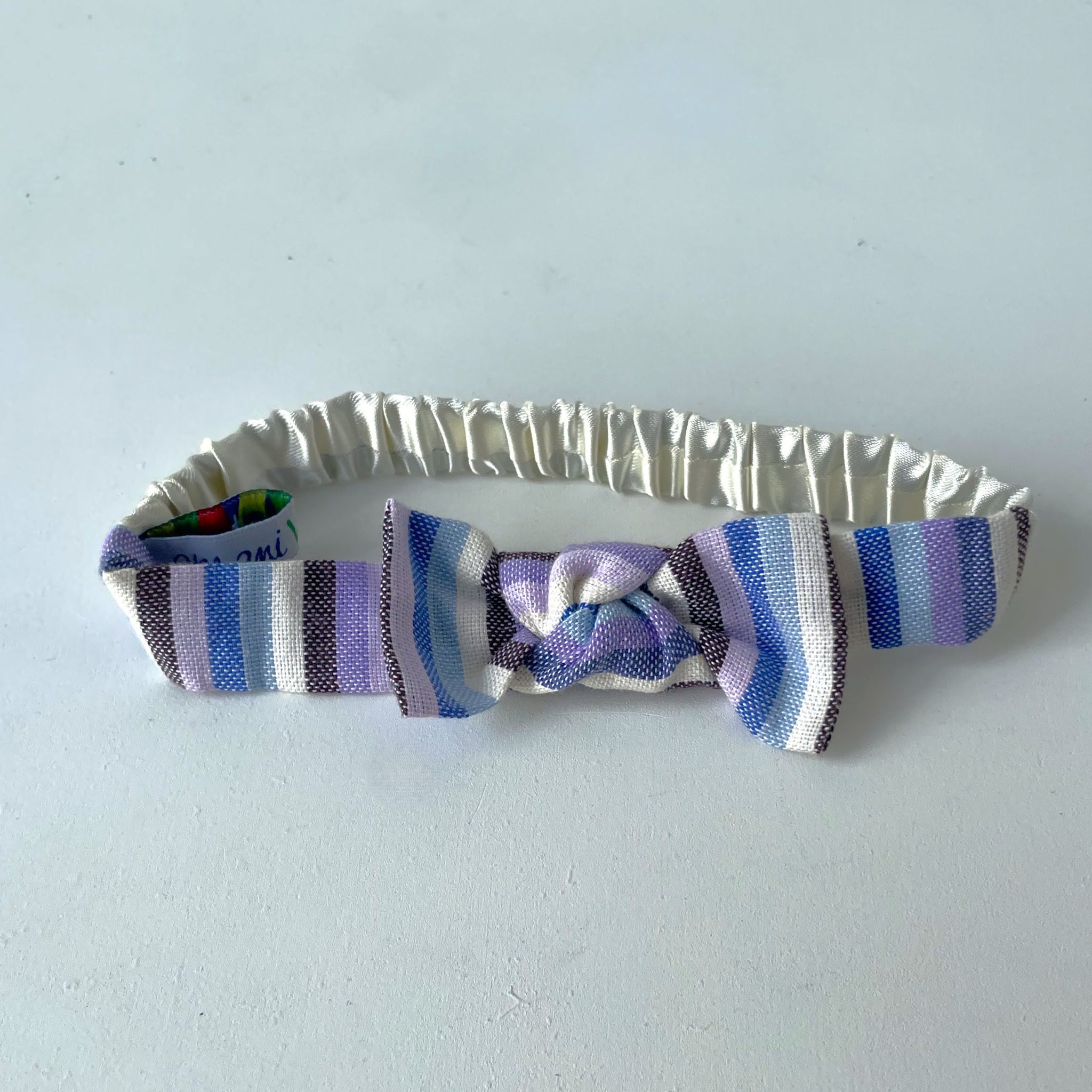 Striped headband with a knot on a light background