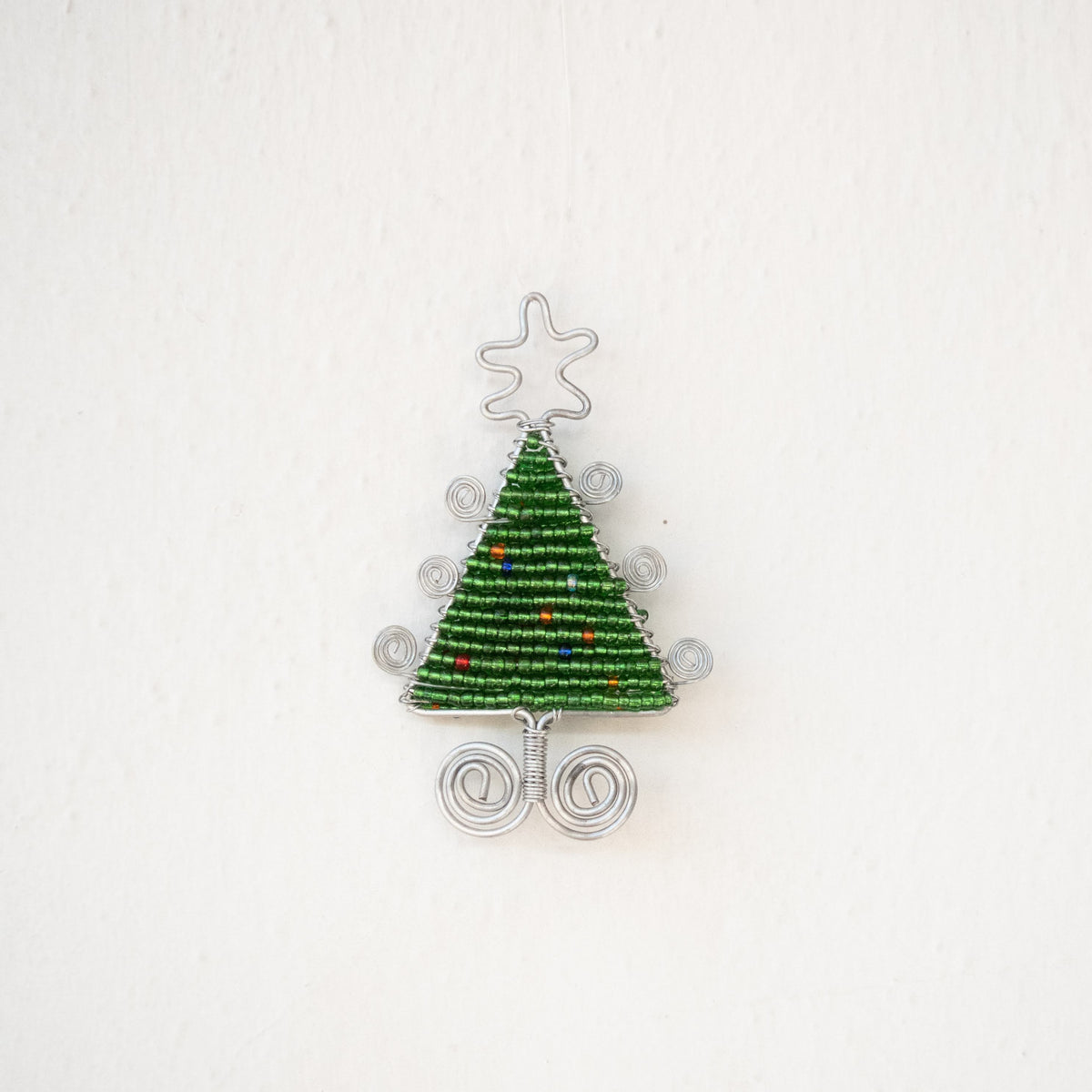 Beaded Christmas tree ornament on a white background