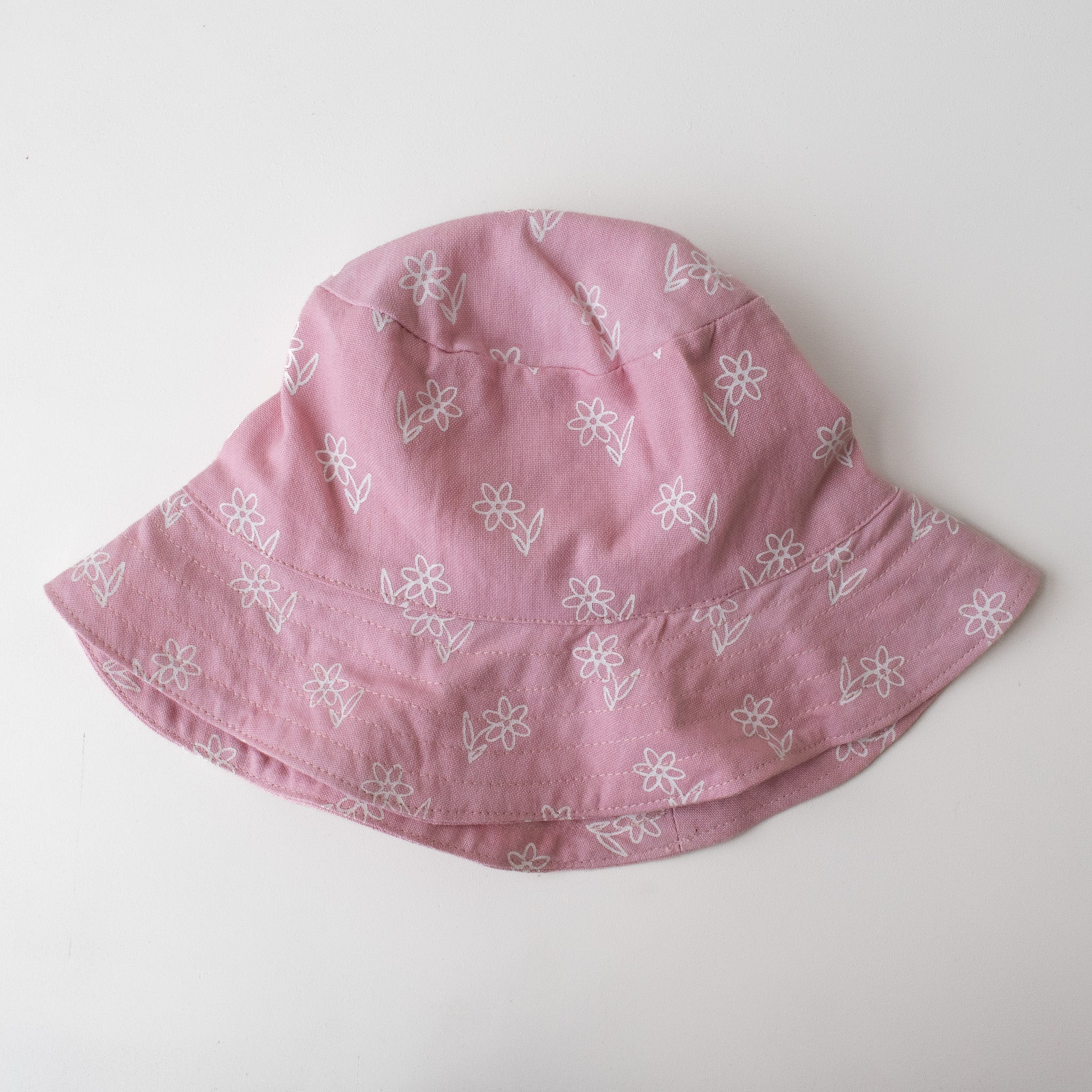 baby bucket hat in pink with screen printed flowers
