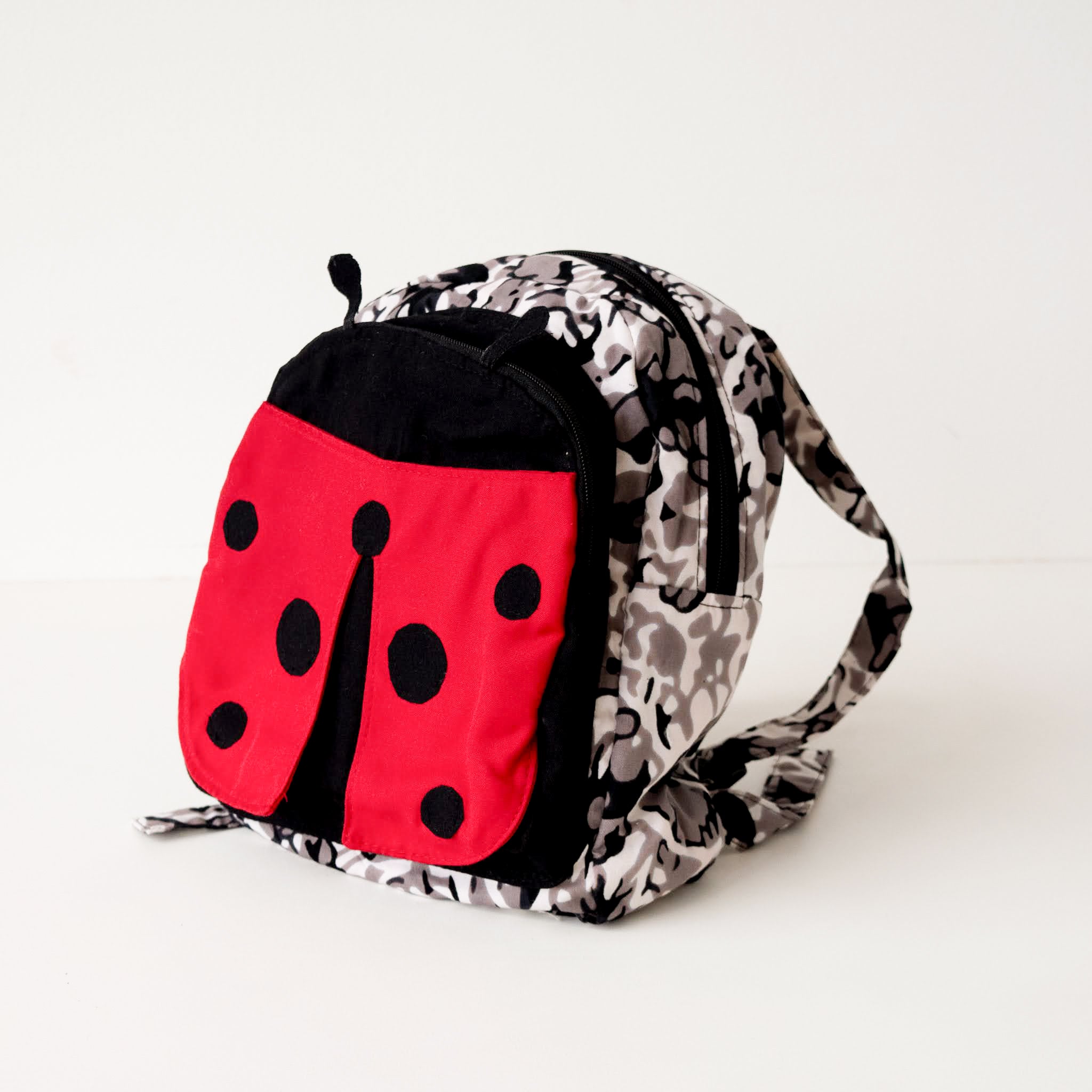 Backpack with ladybug design on a white background