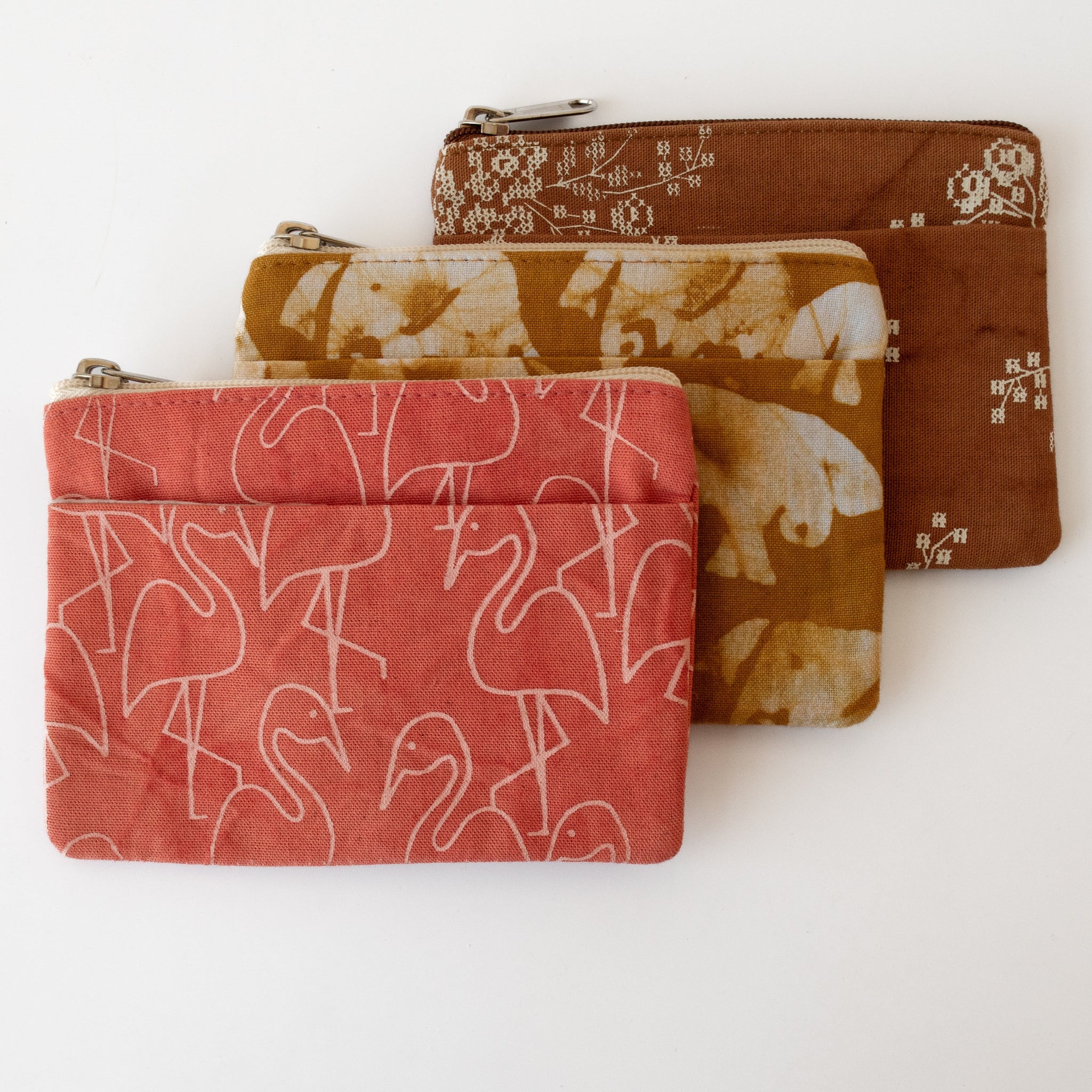 Three fabric pouches with different patterns on a white background
