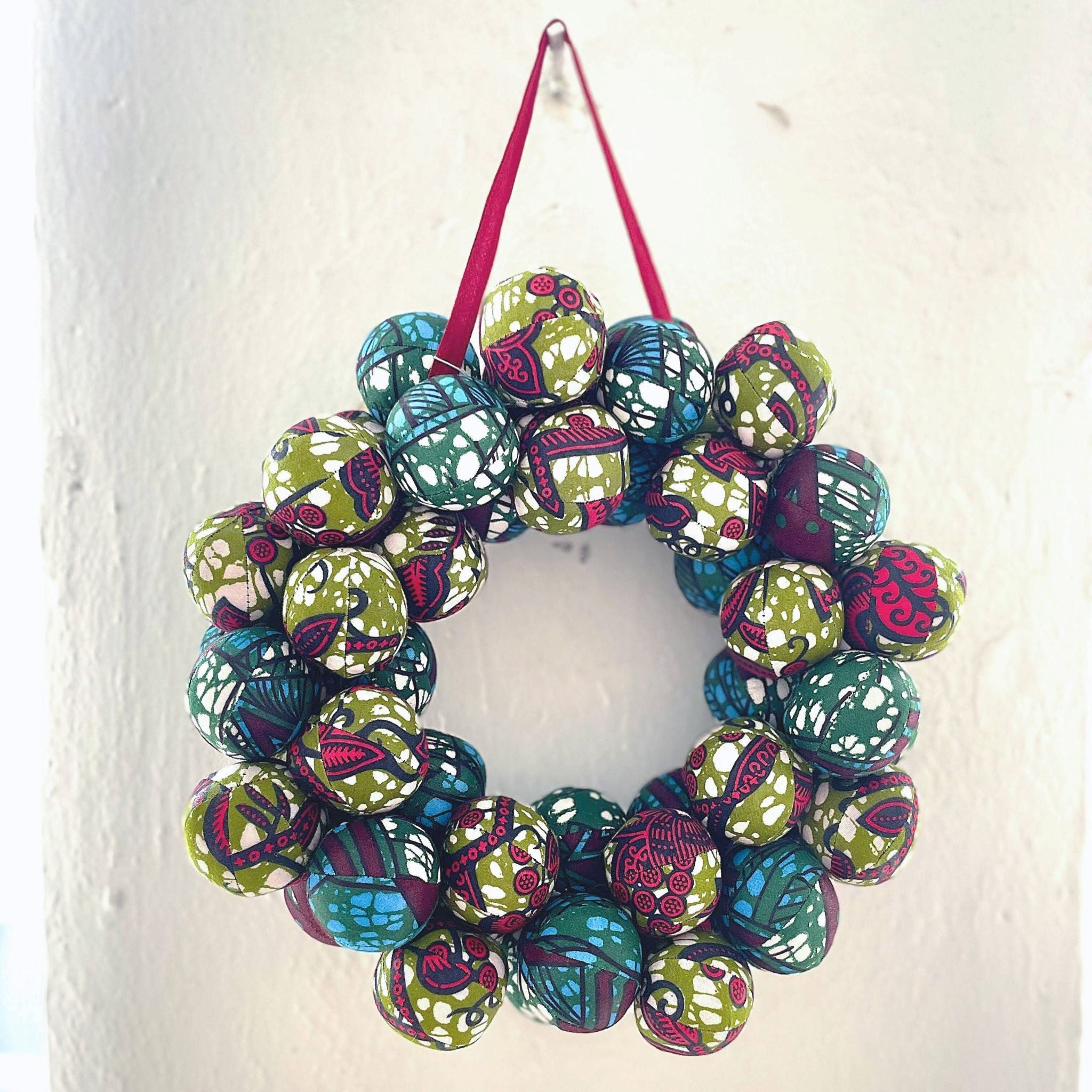 Decorative wreath with colorful spherical ornaments on a white background
